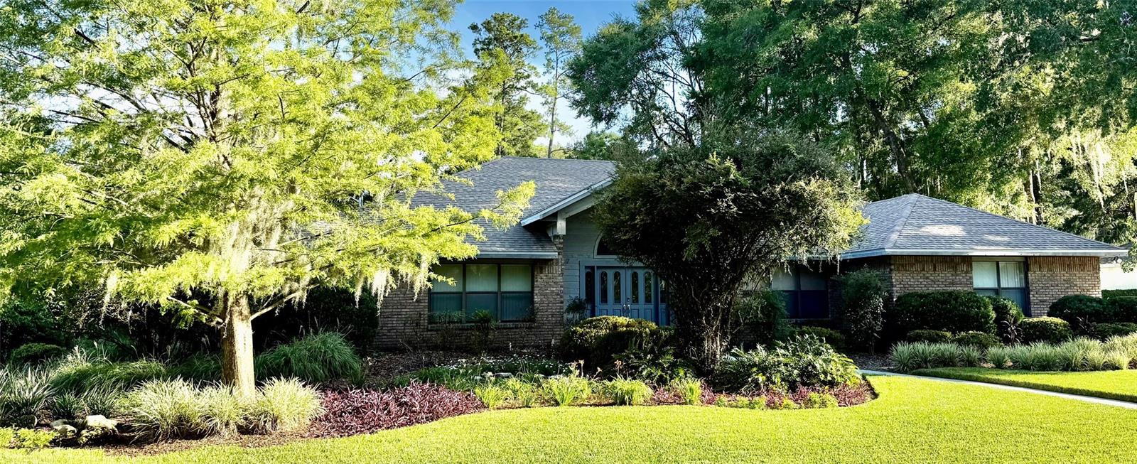 Large Family Home - Great for Entertaining!
5BR / 3.5BA Pool Home in SW Gainesville with custom wading pool, fountain, & hot tub.
3,498sq?ft built in 1988, situated on a lush 0.45-acre landscaped lot in the Avalon subdivision. This home offers flexible living spaces perfect for families, entertaining, or multigenerational arrangements.
One of the best features of the property is the extra large screened pool enclosure, featuring an in-ground heated pool—and a unique one-of-a-kind fountain feature that becomes a stunning focal point by day and sets an elegant mood when lit at night. Adjacent is a gas-heated hot tub/spa, built directly into the pool deck for year-round relaxation or wellness escapes. Pool lighting, outside bath access, and a large, covered outdoor kitchen area with a commercial, stainless steel grill and hood elevate the fun.
Step through multiple sliding door entrances into an airy and inviting interior with vaulted ceilings, tile and hardwood flooring, ceiling fans, and a handsome wood-burning fireplace. The layout seamlessly connects formal living and dining areas with a bright family room and a well-appointed chef’s kitchen featuring a gas range/oven, double wall oven, built-in microwave, wine fridge and enough counter space for meal prep and entertaining.
Outside, the professionally manicured front and backyards delightfully balance form and function. In the backyard, a neatly maintained vegetable garden along with fruit bushes ( blueberry, blackberry, grapes) and fruit trees (mulberry, loquat, fig) supply fresh fruits and vegetables throughout the year. Mature trees, landscaping, lighting, and irrigation provide a tranquil ambiance and privacy. The covered and screened lanai overlooks the pool and garden—a perfect setting for parties, summer barbecues, or sunset relaxation.
Additional highlights include an attached two-car garage, large indoor laundry room, central HVAC with natural gas heating, new energy-efficient gas water heater in 2025, and an architectural shingle roof. The house also has hidden boat/RV parking at the end of the driveway that is currently configured to fit a 35 ft trailer but can be easily reconfigured to accommodate a 55 ft. vehicle.