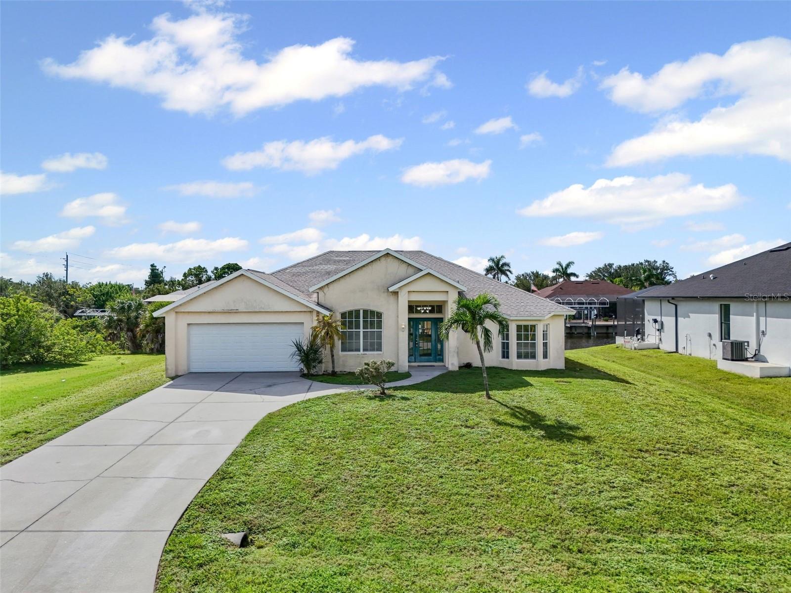 EXCELLENT AS-IS OPPORTUNITY to own a WATERFRONT HOME with a BOAT DOCK & 10,000 LB BOAT LIFT in South Gulf Cove! Priced below market value, ready for you to remodel to your own style & tastes. Includes a new 4.5 ton HVAC, August 2025, new hot water heater, 2024, ready for flooring, paint & roof, updates if desired. Great Floor Plan, Interior features 2 split bedrooms, primary has en-suite bath & walk-in closet, 2nd full bath, Den/Study with double entry French Doors, dining nook in kitchen with large windows facing canal, open Living/Dining area with high vaulted ceilings, designer lighting, ceiling fans throughout, covered screened back porch leading to the Boat Dock. Light & Bright Home ready & waiting for your TLC! Call to see it today, won't last long at this price!