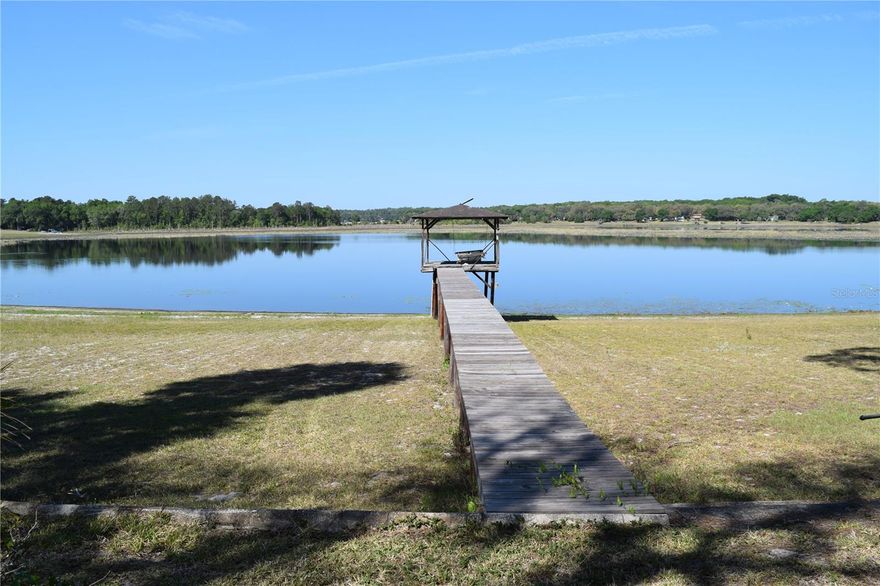 Paradice on the lake.  3 bedroom 2 bath home with fireplace.  Kitchen looks out to lake along with formal dining area and laundry area.  Concrete picnic table under the trees to enjoy the view.  Large workshop 24 x 27 with storage and attic.  Living room windows have glass shelves.  Large workshop with lots of storage.  Drought has lake low and roads are soft.