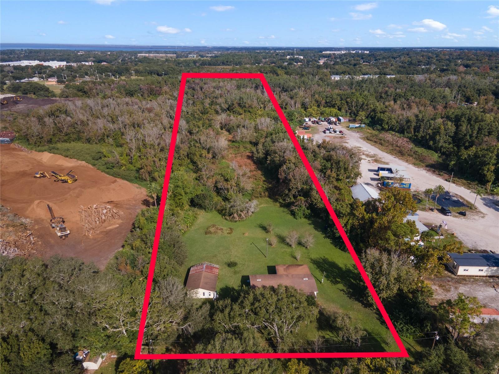 4.5 acres in Ocoee, FL close to everything! This parcel is nestled down a dirt road and offers a haven of privacy. Surrounding properties host commercial uses, opening the door to various commercial possibilities; however, it's advisable to consult with the City of Ocoee to ensure compatibility with your intended use as this property is zoned R-1.
While a significant portion of the property is designated as flood zone AE, the city proactively addressed drainage concerns by digging a ditch along the western edge of the property a few years ago. This ensures that the property drains quickly and has efficient water management.
On-site, you'll find a spacious double-wide and a storage building, but the true value lies in the expansive 4.5 acres of land. This presents an exciting opportunity for those envisioning a large food forest or wanting to utilize the space for large format storage needs.
Whether you're dreaming of a commercial venture or a unique agricultural project, this acreage offers a canvas for your ideas. Embrace the potential, explore the options, and envision the possibilities that this sprawling 4.5-acre property has to offer.