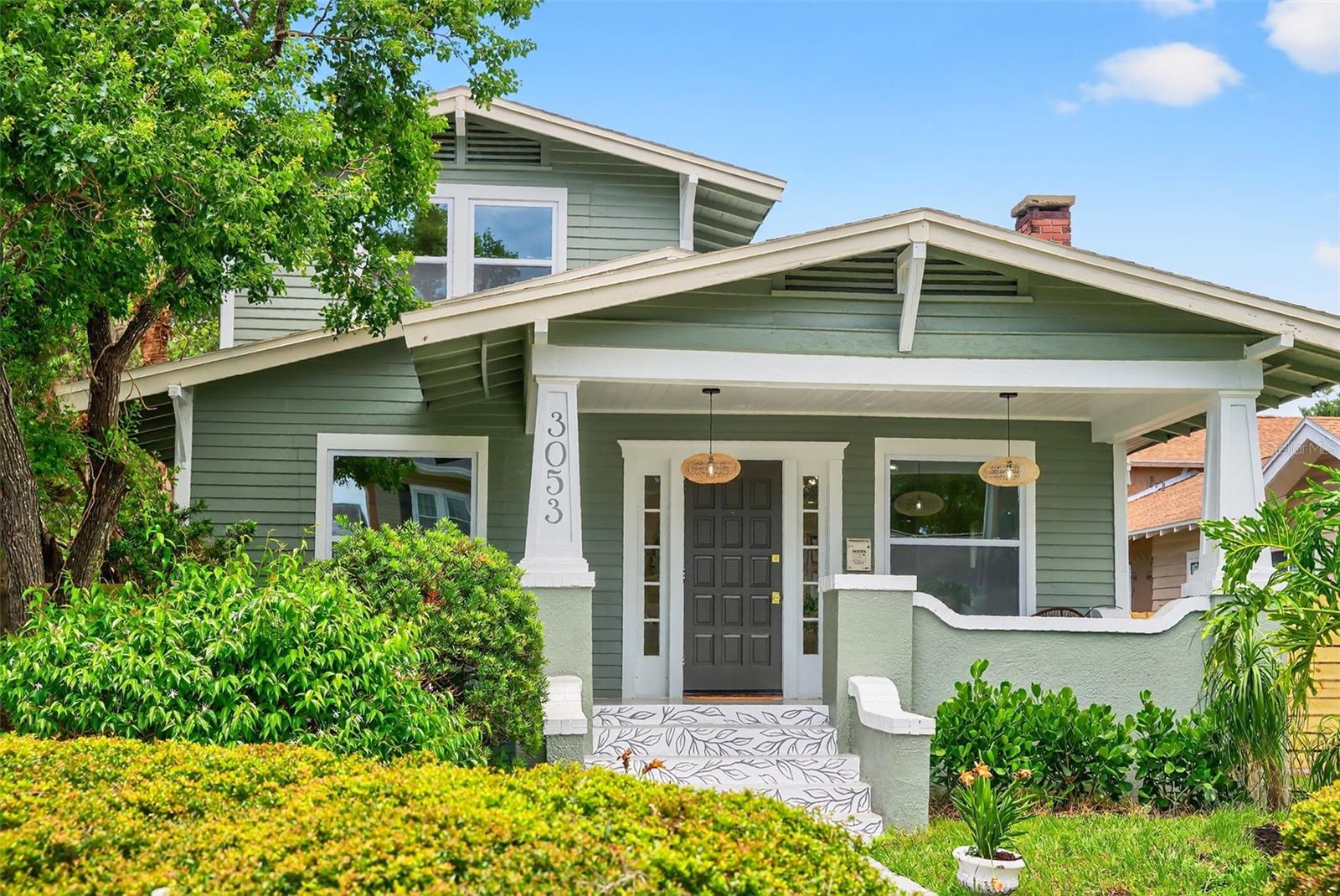Under contract-accepting backup offers. “Classic meets Modern” - This 1928 Historic Kenwood Bungalow has been updated for the modern city dweller, and the “wow” factor at every turn. The large porch welcomes family and friends, as well as being the perfect spot for a neighborhood porch party! Giving a nod to the original floor plan, the home has been designed to include a reimagined kitchen, including a convenient breakfast bar, ample counter space, and loads of storage with custom fixtures and a gas range. The custom-designed green glazed subway tiles are a nod to the 1920s with a modern touch. Entering the home, the living room is anchored by the original fireplace and creates a harmonious blend of historic charm. The room flows seamlessly into the dining room and offers custom-built cabinetry for storage and entertaining, and keeps the charm and character of the home intact. The main floor offers two large bedrooms that share a hallway bath. Up the original staircase, the primary en-suite creates the feel of your own sanctuary with a large bedroom, dual closet, and a bathroom that includes a large wet room with a soaking tub and generous shower area. Beyond the kitchen is a convenient bonus room/office/family room that includes a laundry closet and half bath, which leads out to the rear garden and single-car garage. The rear yard/garden has convenient alley access for the garage and parking. The custom wall design anchors the yard with "Kenwood" blazoned across the wall - Let’s just say it's the best of "Modern meets Historic"; certainly a nod to the modernized City of St. Pete and the love of murals all around! Located in a non-flood zone.