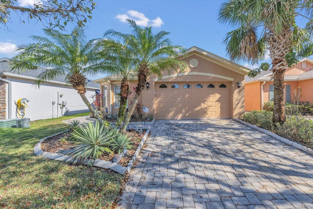 BRAND NEW ROOF! CHARMING HOME IN THE AWARD WINNING COMMUNITY SOLIVITA | Welcome to the nationally award-winning community Solivita. This 2bd/2ba is uniquely private, as the front door lies down your walkway to the west side of the home and includes a screen enclosed entry. This home has been meticulously kept and has been updated with countertops in the kitchen and master bathroom. This open floorplan gem flows seamlessly throughout the living room/kitchen combo, with views out through a large closed-in screen lanai where you will spend many nights enjoying a sizable back yard with your furry ones while taking in the beautiful Florida weather. The kitchen appliances have also been upgraded and you will also appreciate the new epoxy garage floor where you can proudly pull your golf cart and vehicles into. This 24 hr guard gated 55+ oasis encompasses 4300 acres of conservation, ponds, water features and amenities. Within Solivita you will enjoy 2 - 18 Hole PGA Golf Courses, a Driving Range, a Practice Range, 14 Temp Controlled Pools, 2 Amenity Centers complete with the latest equipment, trainers, and classes, pickleball, tennis, horseshoes, bocce ball, softball, and lots of fun. Join any of the endless clubs, visit the library, garden in the community garden or take your dog to the Dog Park. Fish in the ponds, drive your golf cart, walk or take your car to the Solivita Village Center to enjoy entertainment, the restaurants, a lecture, the art studio or shop in the pro shop or our Hometown Pharmacy and Convenience Store. Buy your produce at our Farmer's Market or picnic in the park. Solivita has been designed with fun, enjoyment and entertainment in mind. It is no wonder why Solivita holds awards for one of the top 55+ communities in the country.