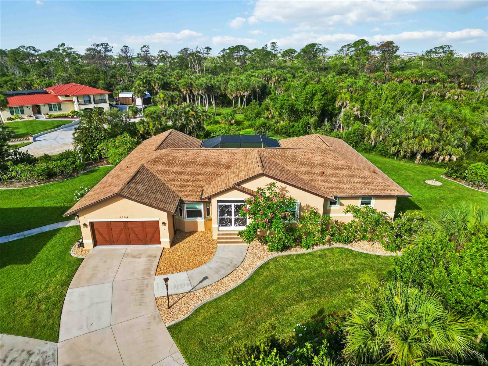 This well-appointed 3-bedroom, 2-bath home sits on just over 1 acre of private land, offering ample space, privacy, and direct access to over 2 miles of scenic nature trails along the Intracoastal Waterway in the South Venice Lemon Bay Preserve—perfect for walking and biking.
A detached garage and workshop with a 1-bedroom suite on the second floor provides extra space for guests, hobbyists, or additional storage. Thoughtfully updated inside and out, this home is designed for comfort, security, and energy efficiency, featuring hurricane impact-resistant windows and sliders in both the main house and guest house, along with accordion shutters on most windows and sliders in the main home.
Notable features include a movie theater room with a 110-inch screen, a heated pool with a brand-new pump (2024), and a Hot Springs spa, making it perfect for entertaining and relaxation. The lanai and front entrance feature new 20/20 screening, offering maximum protection against insects. Additional upgrades include a 10-zone Wi-Fi irrigation system, refreshed landscaping with new plant edging, and a freshly painted and sealed exterior (2024).
Key upgrades include:
*New roofs on the main house (2024) and guest house (2022)
*Whole-house Generac generator powering both homes and the pool, supported by a 1,000-gallon & 250-gallon propane tank
*New drain field and septic system
*Whole-house reverse osmosis system with a new pump (2024) and a deeper well
*New HVAC units (including one for the workshop) with elevated placement and new attic ductwork with four zones
*Central vacuum system in the main house
*New water heater (2022) – Rheem Marathon
This private yet conveniently located estate is move-in ready!! Schedule your private tour today!