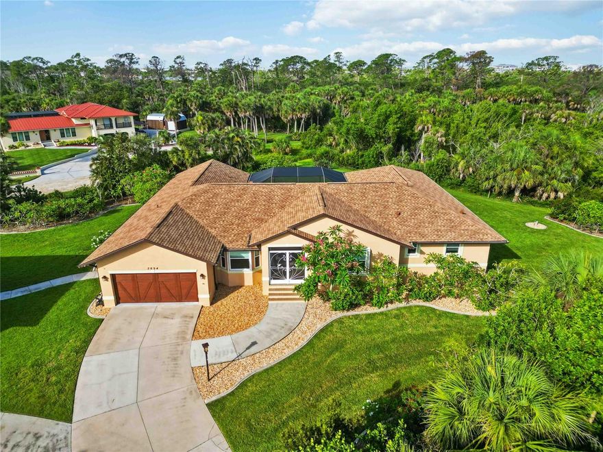 This well-appointed 3-bedroom, 2-bath home sits on just over 1 acre of private land, offering ample space, privacy, and direct access to over 2 miles of scenic nature trails along the Intracoastal Waterway in the South Venice Lemon Bay Preserve—perfect for walking and biking.

A detached garage and workshop with a 1-bedroom suite on the second floor provides extra space for guests, hobbyists, or additional storage. Thoughtfully updated inside and out, this home is designed for comfort, security, and energy efficiency, featuring hurricane impact-resistant windows and sliders in both the main house and guest house, along with accordion shutters on most windows and sliders in the main home.

Notable features include a movie theater room with a 110-inch screen, a heated pool with a brand-new pump (2024), and a Hot Springs spa, making it perfect for entertaining and relaxation. The lanai and front entrance feature new 20/20 screening, offering maximum protection against insects. Additional upgrades include a 10-zone Wi-Fi irrigation system, refreshed landscaping with new plant edging, and a freshly painted and sealed exterior (2024).

Key upgrades include:
*New roofs on the main house (2024) and guest house (2022)
*Whole-house Generac generator powering both homes and the pool, supported by a 1,000-gallon & 250-gallon propane tank
*New drain field and septic system
*Whole-house reverse osmosis system with a new pump (2024) and a deeper well
*New HVAC units (including one for the workshop) with elevated placement and new attic ductwork with four zones
*Central vacuum system in the main house
*New water heater (2022) – Rheem Marathon
This private yet conveniently located estate is move-in ready!! Schedule your private tour today!