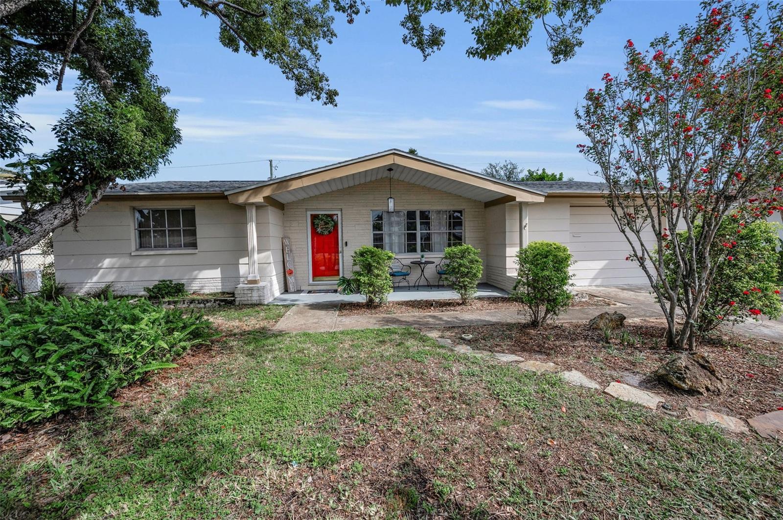 In the heart of Holiday’s desirable Forest Hills community is this cozy 2 Bedroom, 2 Full Bath Home..this great Location is just minutes from Florida’s beautiful Gulf Coast Beaches and has easy access to airports, all shopping and great dining..this home offers the perfect balance of comfort and convenience for any type of a buyer..Spacious Kitchen with Dinette area, 2 bright & airy Bedrooms, plus a combined Living and Dining Entertainment area all with gorgeous new Luxury Vinyl Plank flooring! Sliding doors off this area onto a large enclosed Patio/Porch. Addition of Shiplap on walls of the Foyer and Bath gives warmth to this home as does the new lighting fixtures/ceiling fans throughout. Interior walls and ceilings newly painted in soothing colors. A few of the recent improvements include new faucets in Kitchen and Bath, Refrigerator w/Icemaker new in 2023(plus there is an extra Refrigerator in garage to stay),Water Heater new in 2023, Dryer new in 2025, and best of all new ROOF in 2023..A/C was new in 2020..Gutters and Sprinkler System that is on a Well! Nice sized rear yard which has a storage shed..Extra Parking pad off Garage..This home is ready to welcome its new owners!