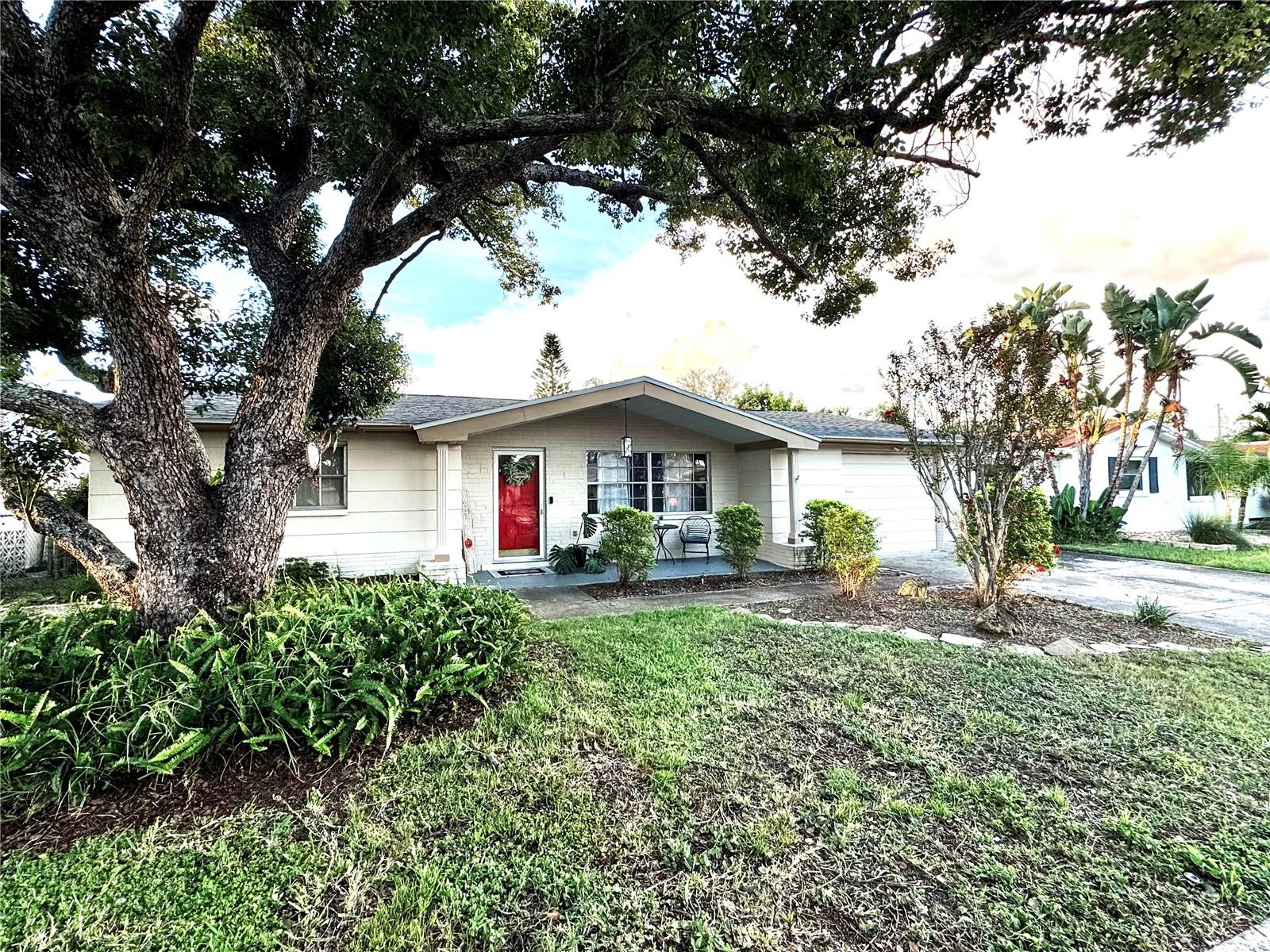 In the heart of Holiday’s desirable Forest Hills community is this cozy 2 Bedroom, 2 Full Bath Home..this great Location is just minutes from Florida’s beautiful Gulf Coast Beaches and has easy access to airports, all shopping and great dining..this home offers the perfect balance of comfort and convenience for any type of a buyer..Spacious Kitchen with Dinette area, 2 bright & airy Bedrooms, plus a combined Living and Dining Entertainment area all with gorgeous new Luxury Vinyl Plank flooring! Sliding doors off this area onto a large enclosed Patio/Porch. Addition of Shiplap on walls of the Foyer and Bath gives warmth to this home as does the new lighting fixtures/ceiling fans throughout. Interior walls and ceilings newly painted in soothing colors. A few of the recent improvements include new faucets in Kitchen and Bath, Refrigerator w/Icemaker new in 2023(plus there is an extra Refrigerator in garage to stay),Water Heater new in 2023, Dryer new in 2025, and best of all new ROOF in 2023..A/C was new in 2020..Gutters and Sprinkler System that is on a Well! Nice sized rear yard which has a storage shed..Extra Parking pad off Garage..This home is ready to welcome its new owners! Professional Photos coming soon!