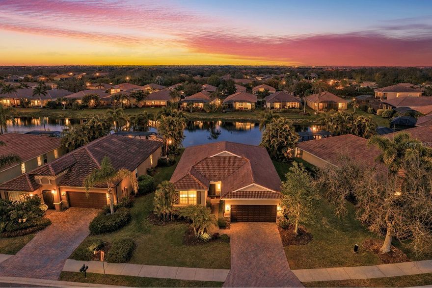 Welcome to River Strand — where refined elegance meets the effortless beauty of Florida living.

Perfectly positioned behind the prestigious gates of River Strand Golf & Country Club, this LIGHTLY LIVED-IN, WATER-VIEW, GOLF DEEDED, Siesta floor plan offers an exceptional blend of luxury, comfort, and resort-style amenities. With 3 bedrooms, 2 bathrooms, and a spacious two-car garage, this single-family residence is designed for those who appreciate both sophistication and serenity.

From the moment you step inside, you’re greeted by sweeping, uninterrupted water views that set the tone for the entire home. The open-concept design allows natural light to pour through expansive sliding glass doors, seamlessly connecting the living room and kitchen — ideal for both relaxed everyday living and stylish entertaining. Tray ceilings with crown molding elevate the main living space, while the screened lanai invites you to unwind with sunset cocktails and tranquil waterfront evenings.

The gourmet kitchen is as functional as it is beautiful, featuring a generous solid-surface breakfast bar, stainless steel appliances, rich cherry wood cabinetry, and an exquisite backsplash — the perfect backdrop for everything from casual brunches to elegant dinner gatherings.

Retreat to your private owner’s suite, where peaceful water views create a true sanctuary. The spa-inspired ensuite bath offers dual vanities, a deep soaking tub, a walk-in shower, rich wood cabinetry, and an expansive walk-in closet designed to keep everything effortlessly organized.

Throughout the home, elevated finishes — including luxury flooring, crown molding, and pristine condition throughout — reflect pride of ownership and timeless quality.

As a golf-deeded homeowner, you’ll enjoy full access to the extraordinary lifestyle that makes River Strand so sought after. Centered around a 27-hole championship golf course, the community also features a newly renovated terrace bar and restaurant, a spectacular clubhouse with fine dining, 2 resort-style pool complex, six additional pools, nine tennis courts, eight pickleball courts, and a vibrant calendar of social events that make it easy to connect and thrive.

This is more than a home — it’s a lifestyle defined by luxury, leisure, and breathtaking water views.

Experience the very best of Florida living at River Strand. Schedule your private showing today and step into the life you deserve.