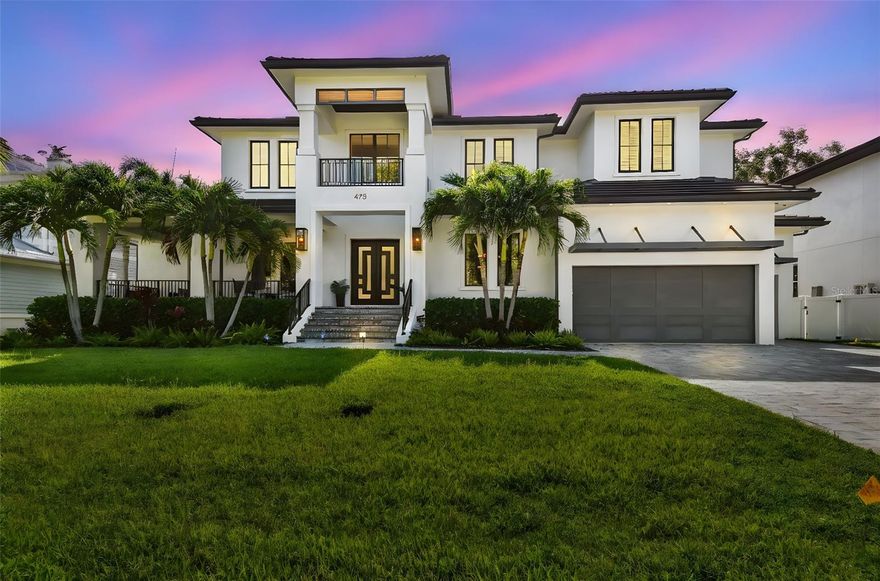 Now available: a stunning Davis Islands custom estate offering 5,615 sq ft of luxurious living space. This 2019 custom-built home features 5 bedrooms, 5.5 bathrooms, a 5-car garage, and a resort-style backyard—all situated on an oversized 100 × 123 ft lot in one of Tampa’s most sought-after neighborhoods. The main level showcases a dramatic two-story foyer, formal dining room, private office, and an open-concept kitchen and living area with wide-plank wood floors and a gas fireplace. The chef’s kitchen includes an oversized waterfall-edge island, premium appliances, and a large walk-in pantry. Three sets of French doors open to a 40-ft sunroom that connects seamlessly to the travertine patio, complete with a covered lounge, outdoor kitchen, heated saltwater pool and spa, and a pizza oven imported from Italy—perfect for entertaining in style. A full guest suite on the first floor is ideal for visitors or multigenerational living, and a dedicated pool bath provides convenient access from the outdoor living area. Additional features on the main level include a full laundry room, with a second laundry room located upstairs for added convenience. Upstairs, the expansive primary suite features a tray ceiling, spa-style bathroom with freestanding tub and dual vanities, and a huge walk-in closet. Three additional en-suite bedrooms and the second laundry room complete the upper level. Additional highlights include a spacious 5-car garage with epoxy flooring and built-in storage, concrete-block construction, impact-rated windows, zoned HVAC, tankless water heaters, smart-home wiring, and whole-house irrigation. Live the Davis Islands lifestyle—just minutes from Downtown Tampa and within golf cart distance of top-rated schools (Gorrie/Wilson/Plant), cafés, parks, the yacht club, boat ramps, tennis courts, and a private airport.