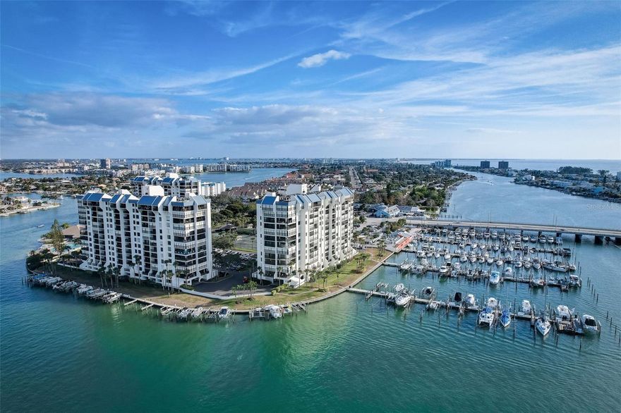 WATERFRONT 2/2 in luxury Yacht & Tennis Club of St Pete Beach.  This lovingly maintained 2-bedroom, 2-bath residence features a bright, open floor plan perfect for both relaxing and entertaining. The beautifully updated kitchen boasts a stylish island and contemporary finishes, seamlessly flowing into the living and dining areas. Admire the coastal-inspired quartz countertop and backsplash, that coordinates beautifully with the white raised panel cabinets.  There is even a cabinet to store your fishing poles!!  The spacious primary suite offers a private en suite bath with a sleek walk-in shower, while the versatile second bedroom includes a custom office setup with a convenient Murphy bed—an ideal room for guests or remote work. Step out onto your private balcony and take in breathtaking views, the perfect backdrop for morning coffee or evening sunsets. Located in a desirable high-rise within the Yacht and Tennis Club, this unit provides added security and peace of mind with hurricane shutters and an elevated position that enhances both natural light and panoramic scenery. A water heater replacement in 2026 adds extra value and reliability and the storm shutters add peace of mind. Please note this is a non-smoking building.  Enjoy resort-style living with exceptional amenities including a waterfront heated pool and spa, saunas, state-of-the-art fitness center, 7 HarTru tennis courts with two lined for pickleball, modern clubhouse, marina access with boat slips, and 24-hour manned gated security. Enjoy an active social life with lots of community activities, or enjoy a laid-back beach vibe with the pristine local beaches a short distance away.  Lush, well-maintained grounds and scenic walking paths and boardwalk complete the experience. All this just moments from top-rated restaurants, shopping, and the beautiful Gulf beaches—offering the ultimate blend of luxury, convenience, and the Florida coastal lifestyle.  Make your appointment today!