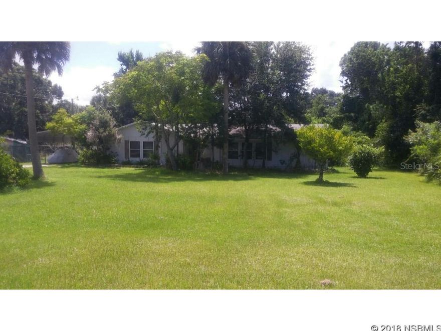 Looking for a large home where you can Park all of your toys or have room for a large family.  This home is close to everything but still has the Open Urban feel. Just 10 Minutes from the Beach and 5 from the Intracoastal Waterway.  Close to shopping and restaurants. 3 Bedroom and 2  baths with 2 1/2 baths. With approx. 2574 square feet of living space, split bedroom plan, Florida Room, Large Family/ dining room and fireplace this home is perfect for the large family.  It also features a separate area that could be a Mother in Law Suite  with a room large enough for a bedroom, sitting area a large closet and 1/2 bath and its own separate entrance or could be used for an office.   2 large utility rooms with lots of storage.  Enjoy entertaining out by your screened in Pool with Pool House. Situated on a 1/2 acre lot (100X220 Lot) with Mature trees and back yard fenced it  has room for all of your toys.    Home needs TLC and updating but has good bones. You are 1hour  to 1hour :30mins from the Orlando Airports, and Orlando Area Attractions, Cape Canaveral and 1 hour from St Augustine.  Your place in the sun is waiting for you why not call us today.