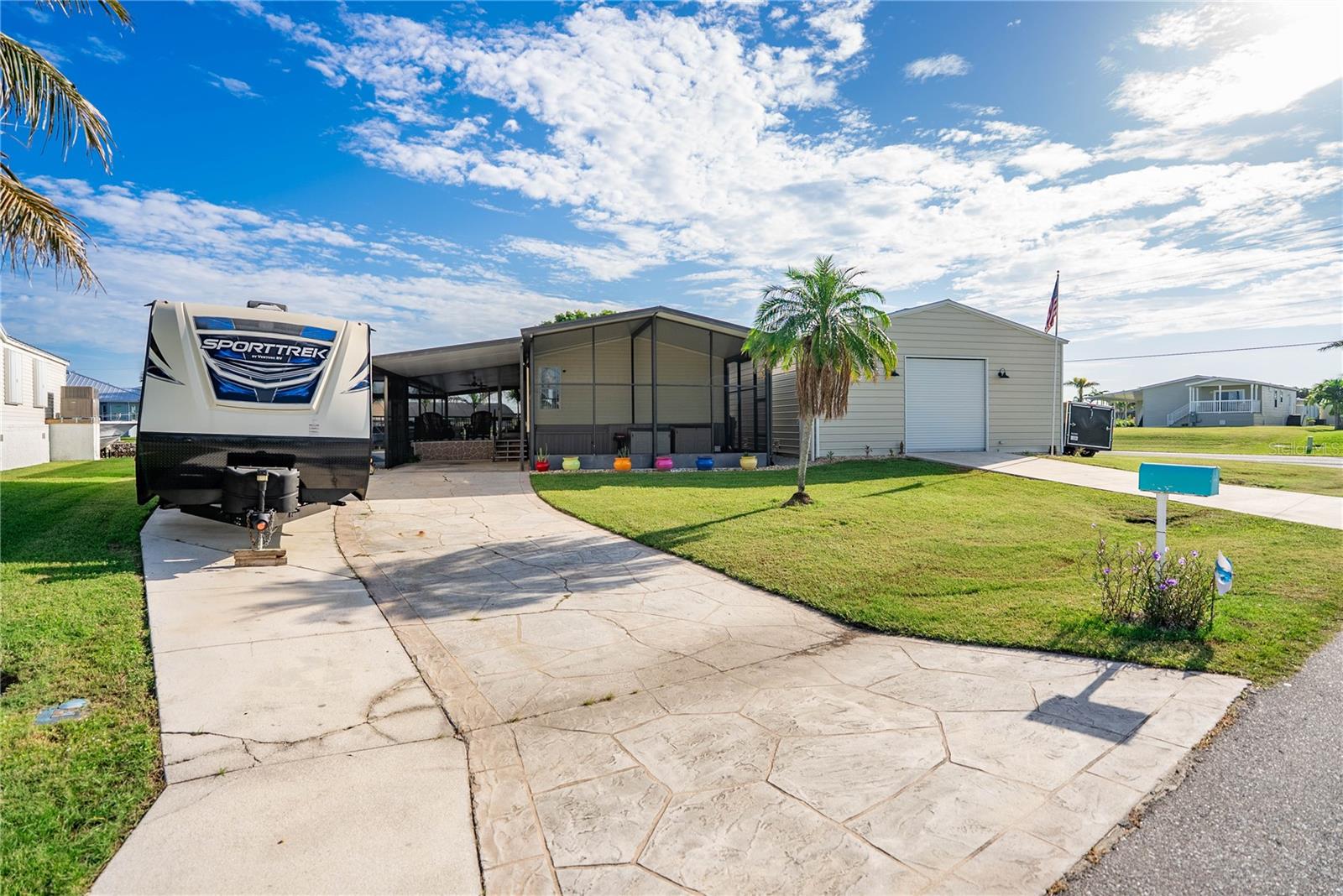 This sail access waterfront home is nestled in the quiet Charlotte Park area on a saltwater canal in beautiful Punta Gorda. Large composite deck and full under truss screen enclosure encompasses the deck and pool. This 2 bed 2 bath home comes with a 1200 square foot detached garage and a 10'x12' storage building. Garage and Storage are both wired for 120v and 240v electrical. The garage accommodates 30, 50 and 60 amp including a connection for an RV. Home has a connection for a generator if new buyer chooses to add one. Home has new A/C, new 200 amp electrical panel and 5" closed cell spray foam insulatation underneath the home. Two docks and a 12,000 pound boat lift that includes new motors, cables, switches and electrical box. Pool resurfaced w/ new pump in Nov. 2024. 10 year transferrable warranty on the pool coating. New Refrigerator. Located 10-12 minutes by boat to Charlotte Harbor. Chlorinated in-ground pool. Half a mile to The Riviera Grill- the neighborhood waterfront restaurant! Located only a few miles from all the waterside parks, waterfront dining and shopping that Punta Gorda offers. County taxes only.