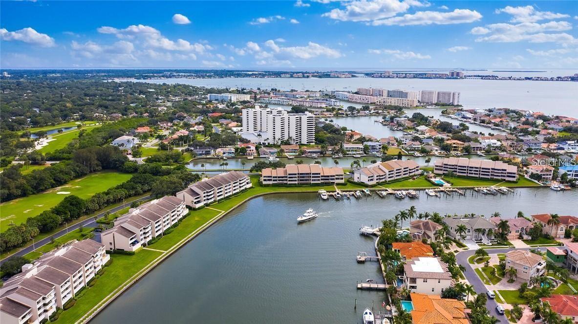 One or more photo(s) has been virtually staged. Come enjoy luxury penthouse living nestled in the gated community of Pasadena Yacht & Country Club! This waterfront boating and golf resort community with the peace-of-mind of a 24/7 guarded gate. Enjoy the stunning view from the penthouse floor of Pelican Bay Yacht Club Condo Building A featuring panoramic views of Boca Ciega Bay, St. Pete Beach, and the Gulf of Mexico! Serene views and sunlit rooms. This luxury condo community has all the amenities you could desire. As soon as you walk through the door you will see the expansive views from every room of this spacious 2 bedroom home. The foyer entry sets the stage with tile floors that leads to the 23x14 great room with sliding glass doors overlooking a 33 foot long covered balcony with the breathtaking views! Beautiful luxury vinyl floors have been added through out the home, a brand new renovated kitchen, with new stainless steel appliances, and gorgeous new lighting. The breakfast nook is perfect to enjoy your morning coffee and watch the dolphins play in the canal! In the oversized kitchen you will have plenty of space to cook and entertain. The home has two primary bedrooms with newly renovated ensuite baths, both featuring roomy walk-in closets. In the main suite you will enjoy the newly renovated walk-in shower with stylish tile walls and hexagon shaped floor tiles. This suite is tucked away with a private entrance to the balcony. Every room has gorgeous 12th floor water views! Your laundry center is conveniently located in between the two bedrooms. The oversized 2nd bedroom has views a beautiful greenery and partial downtown St Pete. It is easy to have a bed, a sofa, and an office desk in this large bedroom. The unit includes a parking space in the parking garage space 28. Luxurious Bldg A, a no pet building, has security entrances, reserved garage parking, impressive 2 story lobby w/spiral staircase, billiards, library, exercise room & the Commodore’s Community Room! The park-like grounds, tranquil pond with lit fountain, heated & chilled pool, in ground spa, saunas, clubhouse & pickle ball courts will help you relax! PLUS w/added membership all the amenities of the Pasadena Yacht & Country Club – Historic Championship Golf Course, Health Club, Olympic Swimming Pool, 82 Slip Marina, 3 Dining Areas & Tennis Courts! Check with the club for details! What a dream to live in this beautiful, sunny Florida neighborhood. From this community it's a walk to the friendly and quirky quintessential beach town of Gulfport, Florida. It's a short stroll to experience all that Gulfport has to offer from the beach, restaurants, bars, night life, art fairs, shopping, community center, beach volleyball, the pier and dances at the "Casino". A quick drive away and you are at the Tampa Bay airports, world famous beaches, galleries, shows, and restaurants. Internet, cable, and water are all included. Come and see how easy living can be. Schedule your showing today to see this bright and cheery place.