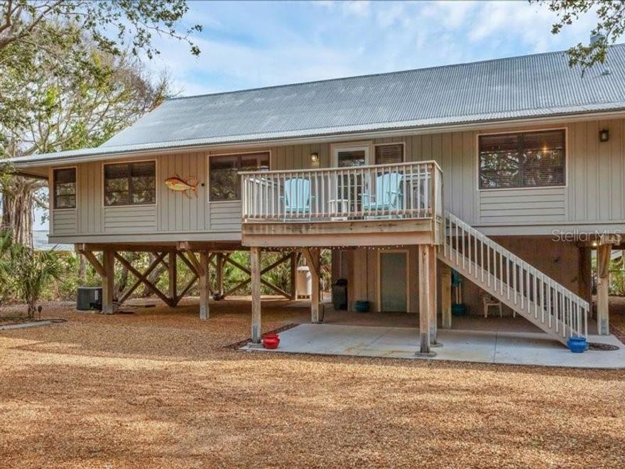 One of the best kept secrets on Manasota Key! An elusive and private sanctuary, 2.6 ACRES, located directly on Lemon Bay with 275 ft. of Bay frontage. This also includes a dock and boat lift with a private 8 foot easement to the Gulf of Mexico. The “elevated” Floridian style 3 bedroom 3 bath residence was built in 1983 and has been maintained impeccably. Volume ceilings, and beautiful hardwood floor throughout, and the living room with a beautiful electric fireplace. Crafted built-in cabinets, drawers and closet throughout. There is a brilliant second level observation deck built for bird and nature watching with stunning views. A unique opportunity regarding this parcel because of the notable size and dimensions of the land. Ideal for a family enclave or the future owner as an investment. It has been favorably investigated for division, however the buyers should seek their own guidelines with the county. There is approval for a second boat lift on the dock. If you have a fondness for serenity and nature this is the ideal home for you! Start each day with an awesome sunrise and jump on your trail to the dock to enjoy an active day on the bay waters with your choice of boating, kayaking, paddle boarding. Or if you prefer the warm waters of the Gulf of Mexico, or you can follow your other trail directly across the street to the beach for shelling, swimming, sunbathing, or surf fishing. You will never tire of the privacy of your magnificent sunsets and the clear starry nights! There is an abundance of decking that surrounds much of the home. Wonderful for entertaining with endless views of lemon Bay. A small fenced in area with a ramp for your pets. There was not any water intrusion in the living area from hurricane Helene or Milton. The house is being sold turnkey.