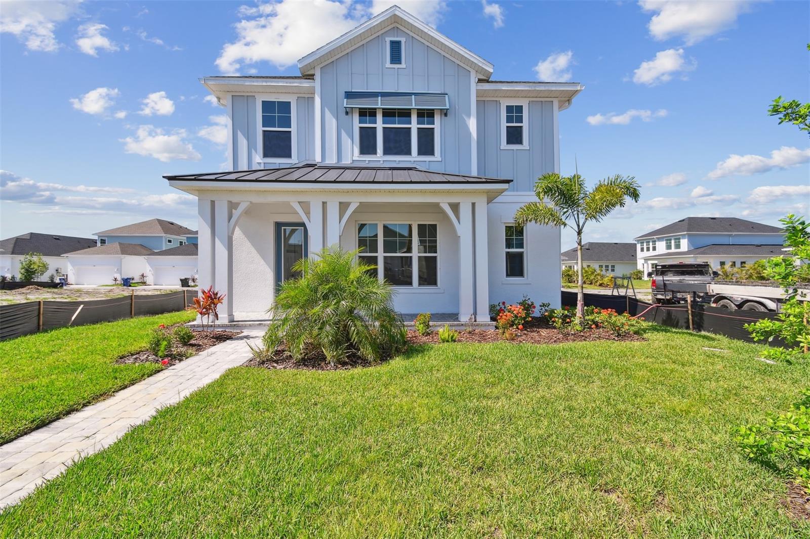 One or more photo(s) has been virtually staged. Make your new home dreams a reality with The Waterfront floor plan by David Weekley Homes in Emerald Landing at Waterside Place. This charming and spacious 4-bedroom, 3.5-bath quick move-in cottage offers style, comfort, and top-quality construction—all within walking distance of the vibrant Waterside Place community.
The main home features 3 bedrooms, 2 full baths, a bonus loft room upstairs, and a sunlit study on the first floor, perfect for working from home or relaxing. The open-concept design centers around a modern kitchen with a gas cooktop, vent hood, built-in microwave and oven, and a large island that overlooks the family and dining areas—perfect for hosting or casual everyday living.
A true retreat, the Owner’s Suite includes a tray ceiling, luxurious en suite bathroom with a free-standing soaking tub, and a spacious walk-in closet. Two additional bedrooms and an upstairs retreat provide private spaces for family or guests.
Adding to the versatility of this home is a separate garage apartment—a private studio suite located above the detached rear-loading two-car garage. With its own private entrance, bathroom, kitchenette, and laundry area, this space is ideal for guests, extended family, or even as an income-producing rental. Combined with the main house, this home offers a total of 4 bedrooms and 3.5 bathrooms.
Step outside to your covered lanai, or enjoy the incredible community amenities, including a resort-style pool, lakeside fire pit, pickleball courts, and dog park. On Sundays, hop on the ferry from the community dock to visit the nearby Farmers Market for shopping or a bite to eat.
You’ll also love the maintenance-free lifestyle, with landscaping handled for you, and peace of mind provided by high-impact hurricane windows—no storm shutters needed.
Come see what it means to be part of the David Weekley Homes family in beautiful Lakewood Ranch. Contact us today to schedule your private tour!