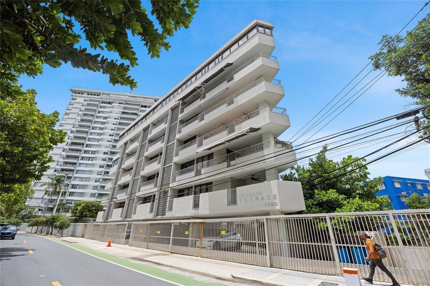 Positioned along iconic Ashford Avenue at Condado Terrace, this residence offers a rare balance of vibrant city living and a relaxed beachfront lifestyle. Ideally located between Condado and Ocean Park, it sits within one of San Juan’s most desirable coastal corridors. Just across the street, miles of uninterrupted sandy beach set the tone for daily walks, ocean swims, and effortless access to the water.

The residence enjoys an ocean view from a beautiful terrace and a seamless indoor-outdoor flow. Spanning approximately 3,060 square feet, the apartment features an open-concept living, kitchen, and dining area, along with 3 bedrooms and 3.5 bathrooms. The layout is thoughtfully distributed to maximize comfort and privacy. Apartment includes 5 inverter A/C units, and 6 ceiling fans. The full kitchen is equipped with a refrigerator, dishwasher, stovetop, and a versatile oven suite including both conventional and microwave/convection options. A private terrace extends the living space and includes a BBQ area, creating an inviting setting for outdoor dining and entertaining.

The home is supported by a water cistern and a full backup generator with an oversized 600-gallon fuel tank that powers the entire apartment. This full-floor residence includes 2 covered parking spaces and offers a level of privacy that is increasingly rare. The property is offered unfurnished, and all artwork and personal items will be removed prior to closing.

Condado Terrace, built in 1965, is a boutique six-floor condominium that reflects the mid-century transformation of Ashford Avenue into San Juan’s “Golden Strip.” Designed in a tropical modern style, the building emphasizes cross-ventilation and indoor-outdoor living. The triangle-shaped structure utilizes reinforced concrete, providing durability against the coastal environment. With only nine residences in total, it offers a private, low-density alternative to larger towers. This is a premier opportunity for a primary residence, second home, or investment in a prime Ashford Avenue location.