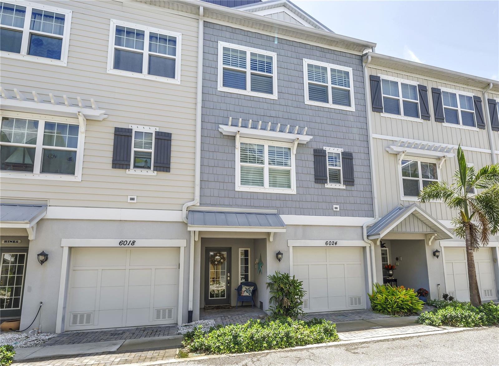 Experience luxury coastal living in this beautifully appointed townhome located in The Cove at Loggerhead Marina — an exclusive, gated waterfront community inspired by Key West charm. Perfect for boaters and nature lovers alike, this community is uniquely situated within the grounds of Loggerhead Marina, with convenient access to its full-service marina and open waterways including Tampa Bay, Boca Ciega Bay, and The Gulf. This three-story, private elevator-equipped townhome features 3 bedrooms, 3 full baths, and a versatile bonus room — ideal as a home office, den, or guest space. Ideally situated along the community's protected nature preserve, the home offers a peaceful, private setting with daily wildlife sightings and serene tree-top views. The main living level features an open-concept design with volume ceilings, 42" cabinets, quartz countertops, stainless steel appliances including a double oven range, a kitchen island, and pantry. Shutters throughout the home provide timeless style and functionality. Enjoy preserve views from the screened-in porch just off the main living area — a perfect space for relaxing or entertaining. Upstairs, the spacious primary suite includes a sitting area with tranquil preserve views, a walk-in closet, and an en-suite bath with double sinks, a seamless walk-in shower, and separate water closet. Two additional bedrooms, a full guest bath, and a laundry room complete this floor. The oversized tandem two-car garage includes generous storage and an epoxy-coated floor — ideal for beach gear, bikes, and more. Step outside to your extended patio oasis, complete with a private spa — a rare feature that overlooks the lush preserve, offering the ultimate in relaxation and privacy. Notably, this property experienced no flooding during recent hurricanes Helene and Milton, offering peace of mind and added reassurance. Community amenities include a resort-style pool with Tiki hut (with cable TV and power), the Captain’s Lounge for events or leisure, walking trails, and community-wide mosquito control included in the HOA dues, in addition to many other covered services and utilities. Just outside the gates, you’ll find access to miles of biking and walking paths throughout St. Pete and Pinellas County.Unbeatable location: only 8 minutes to downtown St. Petersburg, 10 minutes to world-renowned St. Pete Beach, and 25 minutes to Tampa via nearby I-275. Live where refinement meets nature — at The Cove at Loggerhead Marina.