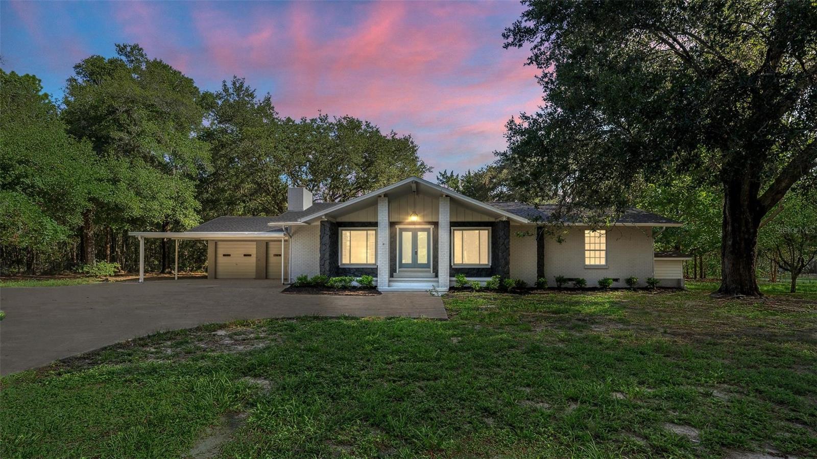 SPACIOUS, FULLY UPDATED 5 bed 3 bath HOME ON 1.3 ACRES—NO HOA FEES & 60x40 RED IRON METAL BUILDING! Discover country-style living with city convenience in this beautifully renovated 5-bedroom, 2-bathroom home boasting 3,055 sq ft of living space and 4,686 sq ft total under roof. Perfectly situated on a sprawling 1.3-acre lot shaded by mature trees, this property offers exceptional privacy and versatility. Step inside to find luxurious Luxury Vinyl Plank flooring throughout, creating a warm and inviting atmosphere. The fully remodeled kitchen impresses with brand new stainless steel appliances, elegant granite countertops, modern cabinetry, and upscale finishes. Both bathrooms have been tastefully renovated, providing stylish comfort and convenience. Enjoy additional space and flexibility in the fully finished basement—ideal for entertainment, hobbies, or extra living quarters. Outside, the enormous 60ft x 40ft metal building at the rear of the property is perfect for storage, workshop space, parking an RV or boat, or running your own business. With NO HOA restrictions, the possibilities are endless! Peace of mind is guaranteed, as both air conditioning units and the roof were replaced in 2021. Don't miss the opportunity to own this rare gem—offering ample space, complete upgrades, and incredible flexibility. Schedule your private showing today!