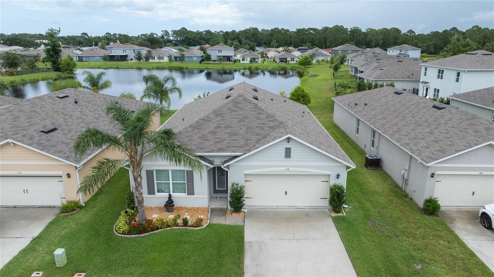 Welcome to this stunning, nearly new lakefront home in the quaint community of Woodbridge Lakes. This modern and elegant Cali floorplan by D.R. Horton offers 1,846 sq. ft. of open living space with 4 bedrooms, 2 bathrooms, a 2-car garage, and serene lake views. Perfect for first-time buyers, growing families, a seasonal second home, all with plenty of space for a home office or exercise room. The primary suite features a walk-in closet, private toilet room, and dual sinks. Upgrades include all new appliances and a front door with built-in glass paneling for additional natural light. Enjoy relaxing on your breezy covered lanai with a favorite book and beverage while taking in the lake views. The kitchen is perfect for entertaining, featuring an island with extra seating and a large pantry. Located close to US1, Whistle Stop Park, New Smyrna Beach, and shopping necessities, this lakefront gem is ready for YOU—schedule your showing today!