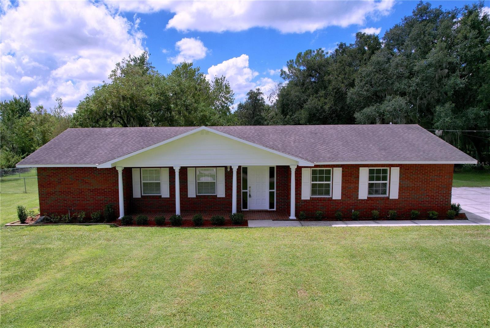 Spacious and well located 4 bed, 3 bath, 2 car garage home on 2+ acres. Recent upgrades include new flooring throughout, new cabinets, countertops and lighting. In addition, the windows, HVAC and water heater have been upgraded as well. A private master bath, two living rooms, and a fireplace help to make life comfortable. Residents will also enjoy the spacious yard, circle driveway and screened back porch. Whether you are commuting to Tampa, Lakeland or just enjoying the Plant City lifestyle, residents will benefit from this home's location just minutes north of I-4. Come take a look today!