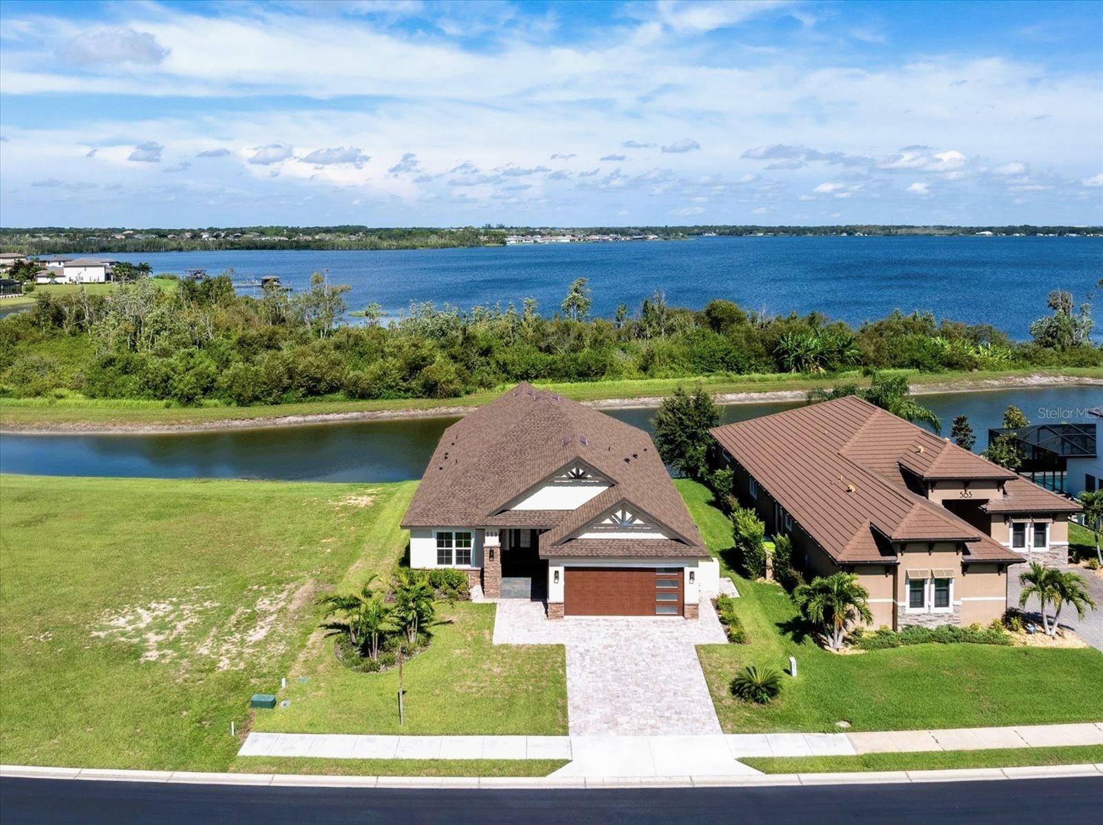 Welcome to this brand-new, waterfront, custom-built luxury home offering exceptional craftsmanship, high-end finishes, and thoughtful design throughout. Nestled in a prime location with breathtaking views of the canal and Lake Van, this home delivers spectacular sunsets and serene waterfront living. Featuring a highly sought-after in-law suite with a private entrance and kitchenette - perfect for multi-generational living, guests, or a private office setup.
Step inside to a spacious and open floor plan featuring 3 bedrooms, 3.5 bathrooms, and premium details at every turn. The gourmet kitchen is a chef’s dream, boasting premium quartz countertops, a matching quartz backsplash, a massive center island, top-of-the-line appliances, custom high-end cabinetry, and a spacious walk-in pantry with built-in shelving. Whether you're entertaining or cooking a quiet meal at home, this kitchen is designed to impress.
The open-concept great room features soaring 12-foot vaulted ceilings and opens to a large lanai through elegant French doors, providing the perfect space to relax and enjoy stunning sunset views over the water and the wooded nature preserve. The formal dining area is framed by a beautiful 12-foot tray ceiling, adding depth and character to the space.
The primary suite offers a luxurious retreat with a spa-inspired bathroom, complete with a soaking tub, large walk-in shower with a rain shower head, and an oversized walk-in closet featuring custom built-ins.
The laundry room is equally impressive, with custom cabinetry, a storage wall, and a sink for added convenience.
Expertly crafted with attention to detail and thoughtfully designed for today’s lifestyle, this custom home offers timeless style, high-end amenities, and exceptional waterfront living.
Don’t miss your chance to own a Dream home in a one-of-a-kind, upscale community with unparalleled Resort-Style amenities. Enjoy multiple Tennis and Pickleball courts, a Basketball court, 3 Pools, Access to 3 Lakes, Boat Ramps, Fishing docks, RV and Boat Storage, a large Fitness center, Sauna and a beautiful clubhouse. Engage in community activities like game nights, social gatherings, and Live Music events, all thoughtfully designed to bring neighbors together, have fun, and create lasting memories. Perfectly located between Tampa and Orlando with easy access to I-4, you’re just a short drive from Universal Studios, Disney Parks, Legoland, premier shopping, dining, and much more!