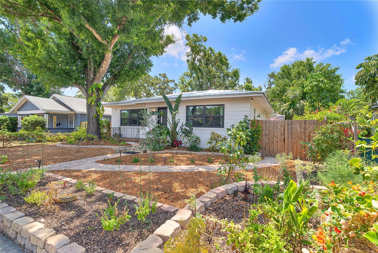 Nestled on a brick street in the Historic Kenwood neighborhood, this beautifully maintained pool home offers the balance of city living with peaceful comfort. Ideally positioned between the vibrant EDGE and Grand Central Districts, you'll enjoy easy access to an eclectic mix of galleries, beloved local businesses, restaurants and bars. This prime location also offers exceptional connectivity to I-275, making travel throughout the city convenient. Interior highlights include a peaceful atmosphere with abundant natural light; as you walk into the main living room you’ll notice original floors and graceful cove ceiling while appreciating the absence of city sounds, thanks to upgraded windows and insulation. The thoughtful split floor plan has two bedrooms with deep reach-in closets, a shared bathroom with tub and additional laundry hook-ups for an optional second laundry space. The beautiful eat-in kitchen features GE induction range and Cafe refrigerator. Large picture windows grace the kitchen and formal dining room, where you’re greeted by built-in service bar with matching granite countertop. The home features over 300 additional heated square feet of multipurpose office space. The private owner’s retreat sits on the North side of the home with separate access to the enclosed patio. Outdoor living is equally impressive, with native landscaping and a heated saltwater pool, enclosed for added comfort and privacy. Behind the property there is alley access w/ parking pad and secure gate. Whether hosting around the tropical pool, tending the garden, or basking in the tranquility of a truly energy-efficient home, this property has it all. As part of the Historic Kenwood Artist's Enclave overlay, this home also offers exciting potential for home-based businesses. The Kenwood Enclave hosts events, further enriching this dynamic neighborhood. Call today for a private tour of this amazing property!