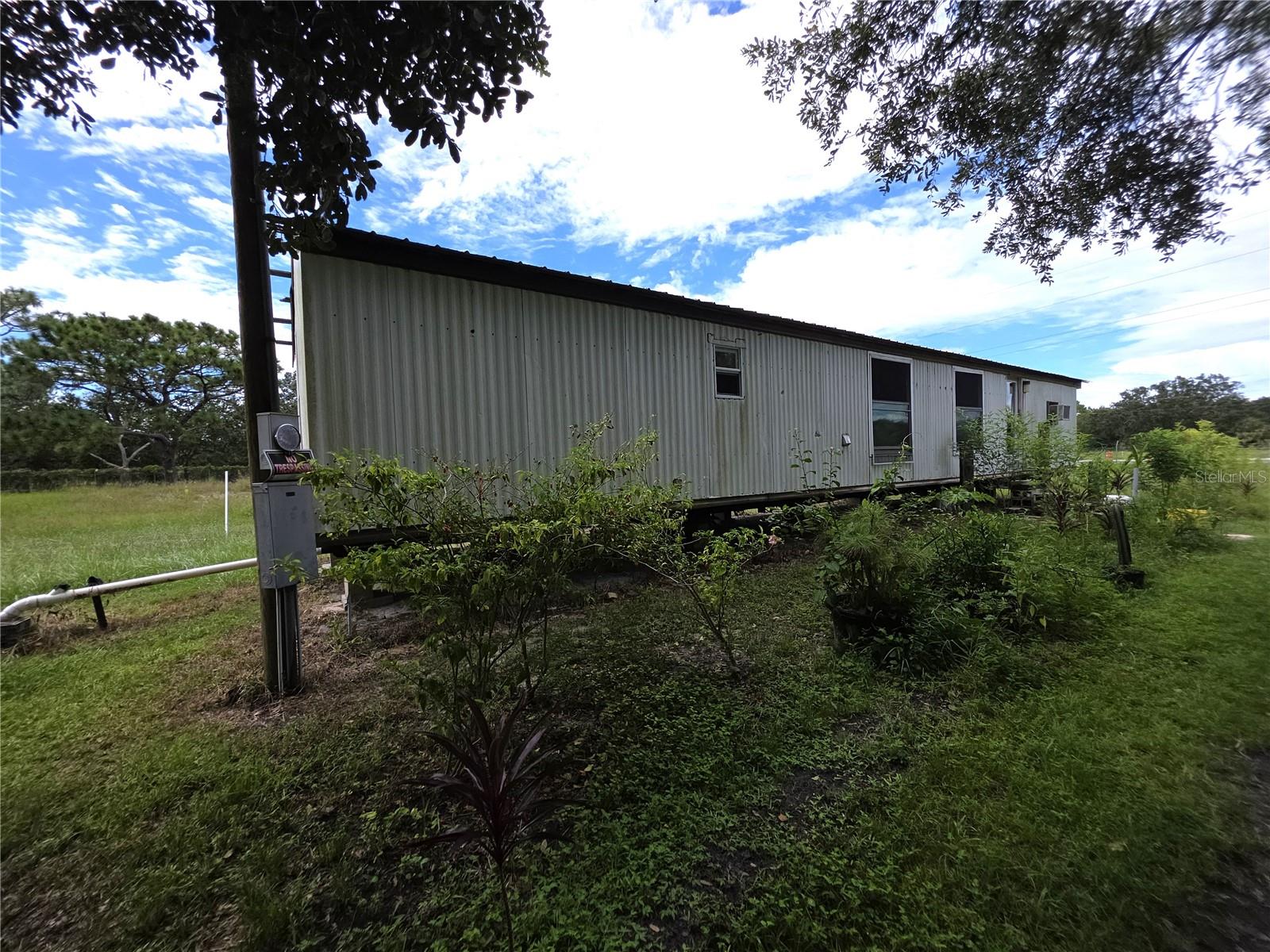 Charming Property with Endless Potential – 2 Acres in Lake Wales, FL - Discover the perfect opportunity to own 2 acres of beautiful, cleared land in the desirable Lake Wales area. This property offers an ideal balance of space, location, and potential. With 2 wells and 2 septic systems already in place, there’s room to add another home, making it a great investment for multi-family living or rental income opportunities. The land features lush greenery and a variety of fruit trees, creating a serene, natural setting. The existing manufactured home on site has been gutted and is ready for renovation, giving you the chance to customize it to your taste or build your dream home from the ground up. Located in a prime area of Lake Wales, this property offers both convenience and privacy. Whether you’re looking to build, refurbish, or expand, the possibilities here are endless.