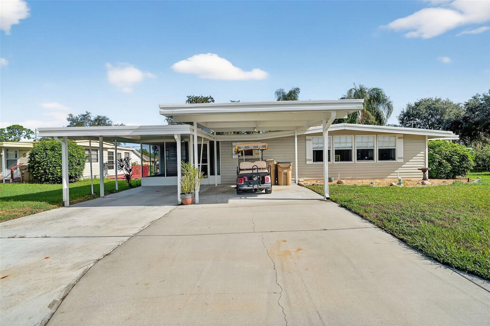 THIS CHARMING 2-bedroom, 2-bath mobile home is nestled in the 55+ community of IMPERIAL TEST WEST (ITW) IN TAVARES. This cozy retreat offers the perfect blend of simplicity and comfort. The vinyl flooring throughout adds a touch of warmth and character to the space. As a FULLY FURNISHED HOME, you can move right in and start enjoying your new surroundings, which include SHADED WINDOW COVERINGS with CURTAIN ACCENTS that allow for lots of SUNLIGHT during the day and PRIVACY at night, SOLID kitchen cabinets, electric stove, microwave and refrigerator/freezer. This home has both a FRONT and REAR screened in Florida style porch. The back yard is fenced in all around for a furry friend, or just for privacy. The room for your WASHER, DRYER AND ADDITIIONAL REFRIGERATOR/FREEZER are at your fingertips just outside the front door. The carport provides ample room for two cars or one car and an ELECTRIC GOLF CART W/CHARGER, which IS INCLUDED in the price of the home. The community's active atmosphere includes planned events throughout the year, along with an indoor POOL and JACUZZI/HOT TUB, LIBRARY, CLUBHOUSE with a POOL TABLE and outdoor SHUFFLEBOARD. There is also a MARINA with BOAT SLIPS to rent, space to store your boat or enclosed trailers, and all with a peaceful serene wildlife like sanctuary surrounding the area. The low HOA of $25/MONTH AND "YOU OWN YOUR OWN LAND" makes this a great place to live! Schedule your showing today!