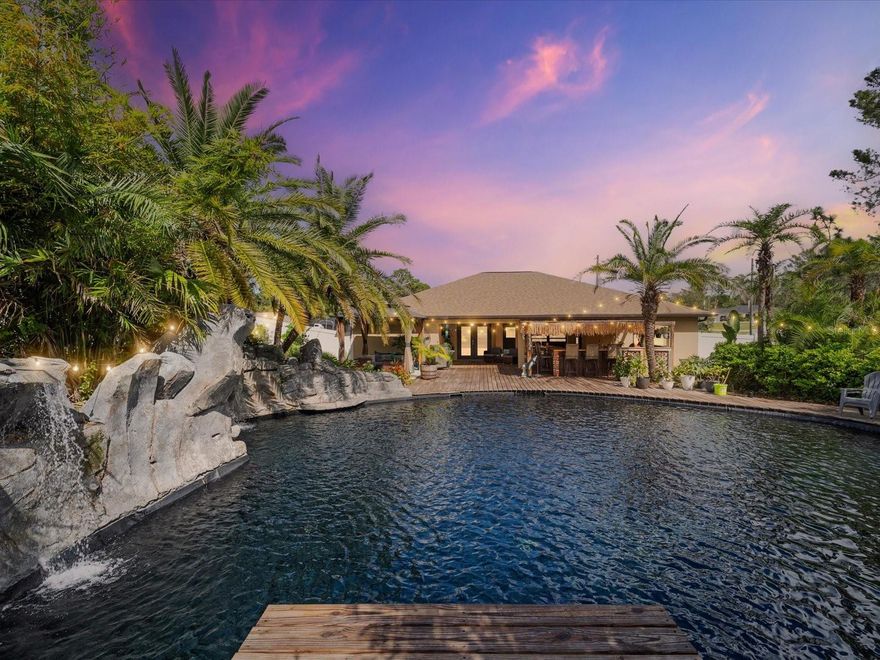 Welcome to the MAVIS LAGOON! This luxury pool home makes you feel like you are living everyday on vacation! This stunning 3-bedroom, 2-bathroom home with a den/office, perfectly situated on a spacious .55-acre lot with no HOA! Built in 2021, this modern beauty combines luxury living with ultimate outdoor experience!Step inside to find a bright, open floor plan featuring a beautiful kitchen with upgraded cabinets, sleek granite countertops, stainless steel appliances, and plenty of space for cooking and gathering. The home offers a split-bedroom layout, a cozy den or office, and a 2-car garage. But the backyard? That’s where the magic happens. Step outside to your tropical paradise a tropical resort-style oasis designed for serenity and relaxation. Dive into a lagoon-style pool surrounded by lush landscaping, complete with six cascading waterfalls and a tranquil back pond that flows into the main pool. Entertain in style on the huge deck with a gazebo and a full tiki bar featuring two mini fridges, a kegerator, ice maker, and sink, the ultimate setup for parties or peaceful evenings under the stars.
The property also includes two storage sheds, a fully fenced yard, and meticulously designed landscaping that makes every corner feel like paradise.This home truly offers resort living without ever leaving home. A one-of-a-kind retreat that must be seen to be believed!