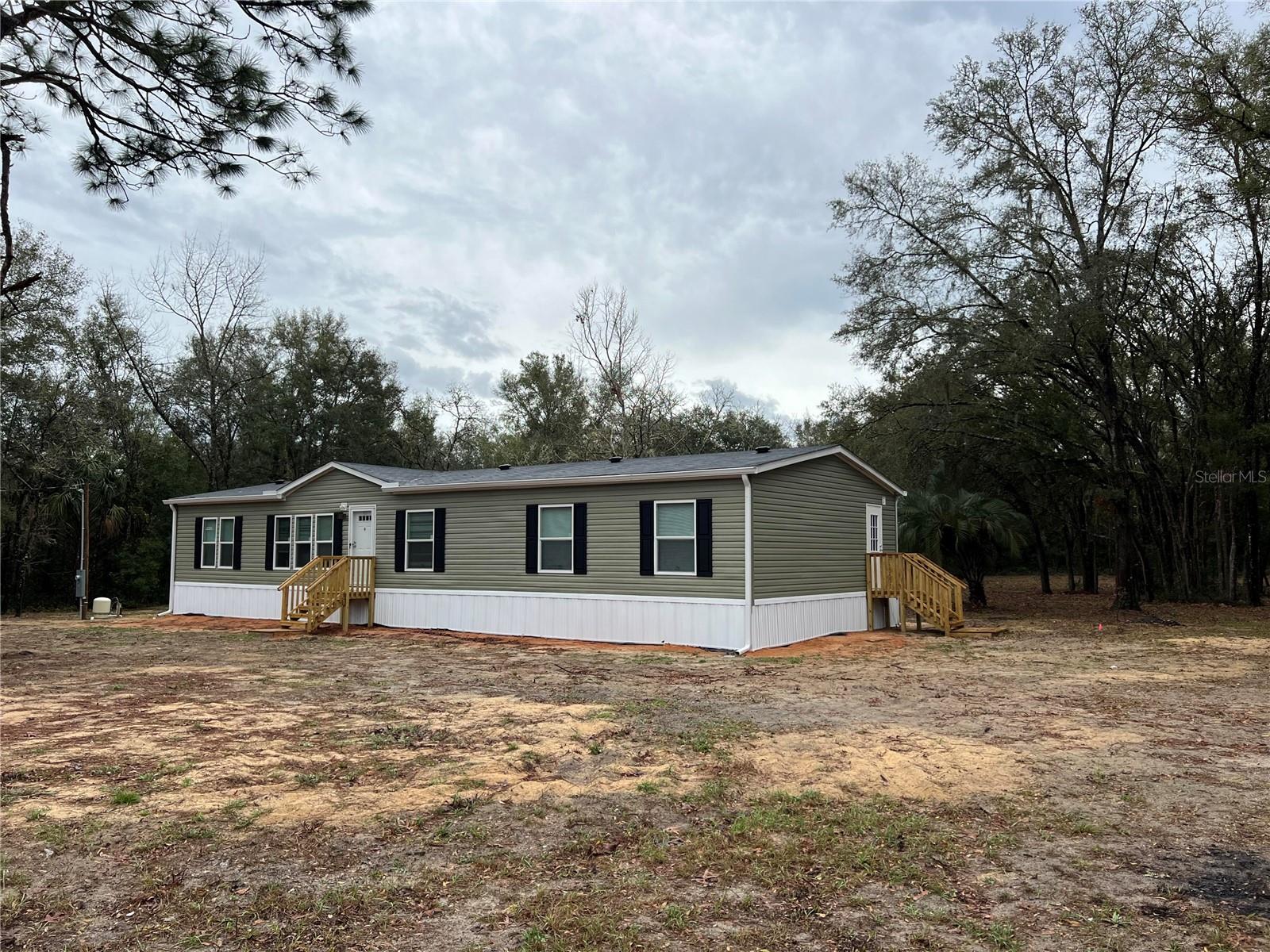 Back on Market – Lending Fell Through! Don't miss your second chance at this 2024 Live Oak Home on 1.25 High & Dry Acres (Zone X – No Flood Insurance Required!) This 4-bed, 2-bath home features a modern open floor plan, two spacious living areas, and a gorgeous kitchen with a large island/dining bar. The primary suite includes a walk-in closet and luxurious soaking tub. Enjoy the mud room with laundry & separate entry, plus multiple access points throughout the home for convenience and flow. Outside, the property is a blank slate with a starter chicken coop and run, ready for your homestead dreams - add a pool, barn, or a garden. This home was tied up in contract for two months, act fast before it's gone again!