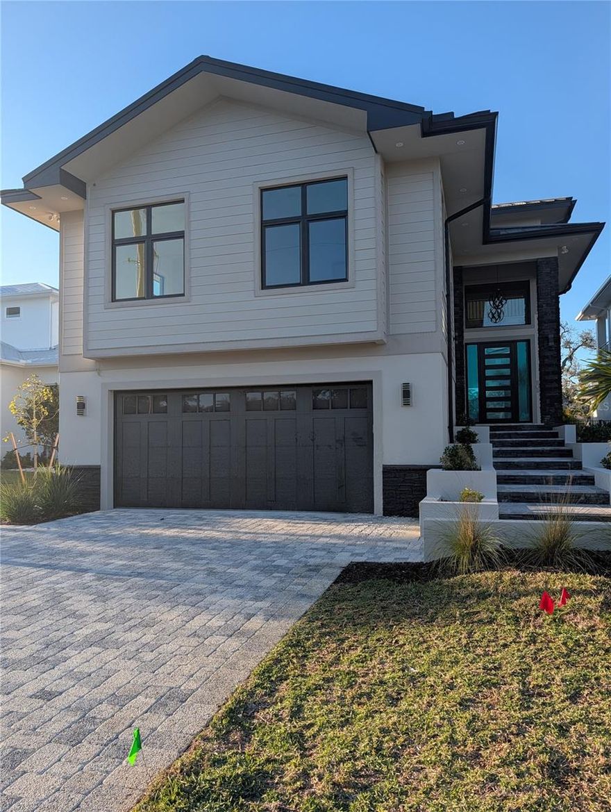 Under Construction. Be the first owner of this exceptional new construction home, expected to be completed in January 2026. Enjoy gorgeous, wide Grand Canal views with quick access to Sarasota Bay—a true boater’s dream.  
This home showcases high-end construction at its core, featuring a standing seam metal roof, hurricane-impact windows and sliders, elegant stone detailing, and meticulous craftsmanship throughout—no detail has been overlooked.
Offering 4 bedrooms and 5 bathrooms, including a pool bath and an additional half bath, the layout is both luxurious and functional. Enter through the grand foyer with soaring ceilings, custom trim work, and striking shiplap accents. The open floor plan seamlessly connects the grand room, dining area, and bonus space, all leading to a stunning pool and patio with outdoor kitchen, perfect for entertaining.
The chef’s kitchen is beautifully appointed with stone countertops, custom cabinetry, and premium finishes, complemented by matching stone counters and custom cabinetry in all bathrooms, creating a cohesive and elevated design throughout the home.
Custom wood decking winds its way to the dock, enhancing the waterfront lifestyle. The home also features laundry rooms on all three floors, a spacious loft, and thoughtfully designed primary and guest bedroom suites.

This is a rare opportunity to own a meticulously crafted waterfront residence designed for luxury living and boating enthusiasts alike.