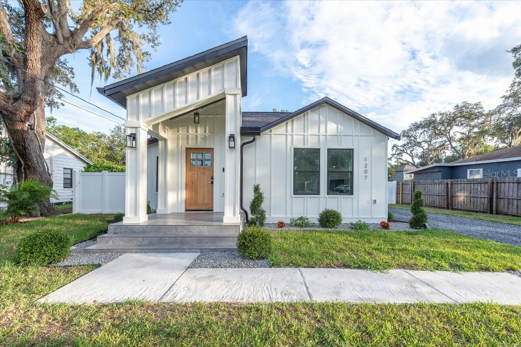 This stunning 3-bedroom, 2-bath modern farmhouse in Seminole Heights has been almost entirely rebuilt with contemporary design. Not only was the existing structure extensively gutted and rebuilt, but an additional 1,170 square feet of brand-new living space was constructed. The result: a nearly all-new home that preserves classic charm while offering premium modern living.
Located in a charming neighborhood in Seminole Heights with custom curb appeal, this home features a dramatic architectural design, luxury finishes, and thoughtful upgrades throughout.
Step inside to find a fully open layout with a designer kitchen featuring a quartz waterfall island, stainless appliances, and custom cabinetry. The living space is elevated by magnetic track lighting, elegant trims, and wide-plank luxury vinyl flooring.
The spacious primary suite includes a custom walk-in closet and a spa-style bathroom with quartz dual vanities, backlit mirrors, and a dramatic stone-lined shower. Two additional bedrooms give generous space and storage, with a guest bath that feels like a boutique hotel. A dedicated laundry room includes full-size Samsung appliances, quartz folding surfaces, and storage.
Structural overhaul details:
The former existing structure has been rebuilt up to 90% new. The only things that were kept on the former existing structure are roof trusses, a few wall studs and floor joists! Everything else has been replaced with new material. Photos and videos of all structural upgrades are available.
Outside, enjoy a beautifully-crafted rear deck, large fenced backyard, and stunning evening lighting. The oversized gravel driveway fits 4+ cars and includes a dedicated EV charging outlet. A full underground gutter drainage system adds peace of mind.
Location — Seminole Heights, Tampa
Nestled in the heart of historical Seminole Heights, this home offers direct access to I-275, providing effortless commuting to downtown Tampa, Ybor City, and the Riverwalk. Seminole Heights is celebrated for its eclectic dining, microbreweries, independent shops, and creative community energy . Just minutes away, residents enjoy local favorites like craft restaurants, parks, and weekend farmers’ markets .
Exterior Benefits:
Oversized driveway fits 4+ vehicles and includes a dedicated EV charging outlet
Elegant 26’ × 10.5’ rear deck with tiered steps and ambient lighting
Fully fenced backyard with mature trees and room for expansion (pool potential)
Underground gutter drainage system covering the entire gutter system for optimal rain water management and functional curb appeal
This home represents the rare combination of architectural integrity, modern and tasteful upgrades, and historical neighborhood charm.
Schedule your private tour today. This home is truly one of a kind.