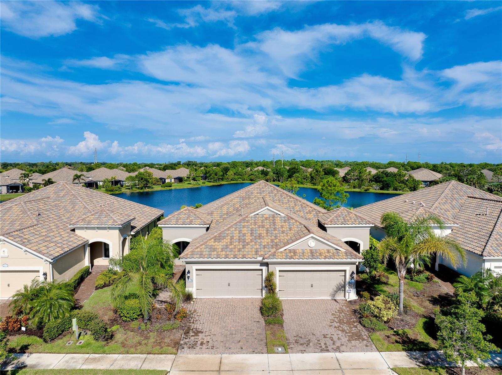 Welcome to this stunning 2-bedroom, 2-bath villa with a versatile den, perfectly blending comfort and style. The open floor plan flows seamlessly into an extended lanai, where you can relax and take in the serene lake view. Inside, enjoy brand-new carpets in the bedrooms, fresh interior paint, and gorgeous new quartz countertops that elevate the kitchen’s appeal. Set within the highly sought-after Grand Palm community, you’ll experience resort-style living every day. Explore Exploration Park, a 10-acre outdoor haven, or visit The Social Club, featuring a full-time lifestyle director, state-of-the-art fitness center, three heated pools, a Splash Park, tennis and bocce courts, and even a private island with fishing piers and walking trails. Perfectly located, this home offers the best of Florida living—just minutes from shopping, Wellen Park, and the charm of Downtown Venice Island. Don’t miss this move-in-ready gem in a sought-after location!