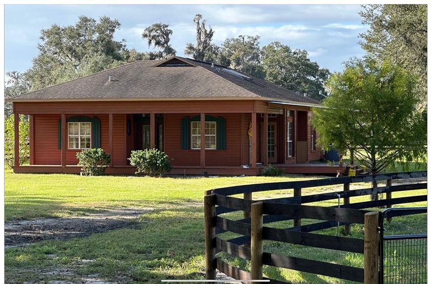 26.6 beautiful acres with a lovely one level custom home in the heart of NW Marion County.  The farm features a private gated entrance and has been recently remodeled with high quality 4 board fencing.  The home is a fantastic 3/2 with laundry and custom designed kitchen and a living room with a fire place that walks out to the back.  This home has been freshly painted, and features ceramic tile throughout, really cool bathrooms, lots of light,  a wrought iron gate designed to help with your dogs if needed and it comes with a new roof, a wrap around porch, and a sweet little back porch lanai…sit out and enjoy the sunsets while watching your equine pals lounge in the most incredible pastures.  There are some beautiful grand daddy oak trees so there is plenty of shade creating soft little breezes during the summer months.  Two barns with plenty of room to get started riding/training, nice paddocks, including a level paddock that is utilized as a grass arena.  Too good to be true; and too good to pass up.  Call for your showing today!