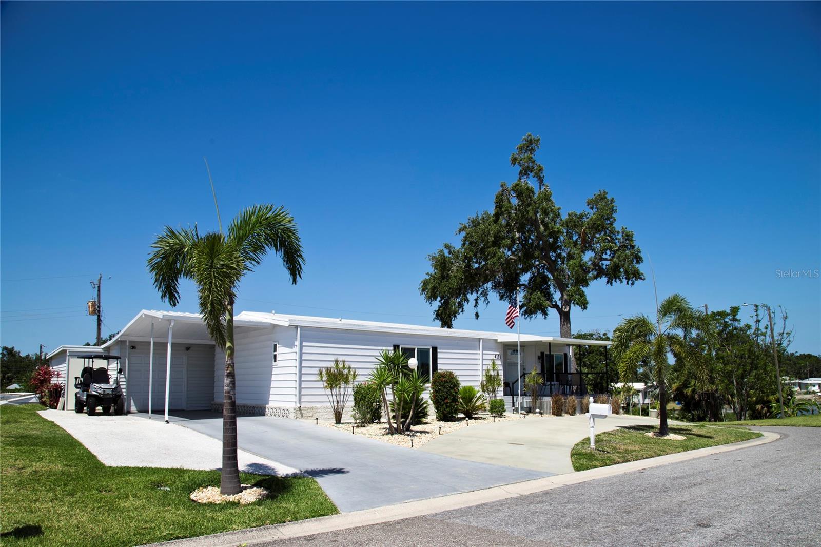 This beautiful home, meticulously renovated, has commanding sweeping water views from living room and front covered porch. If finding an affordable land owned home in a 55+ community with reasonable HOA fees has been your goal, you've found it here right in Tidevue Estates.This home goes above and beyond any other home with a beautifully created living and dining room area. The kitchen contains state of the art stainless steel appliances, new quartz countertops, soft close cabinetry with pantry and built-in brand new range top, oven and microwave. Island kitchen counter is open to living/dining area with elevated ceiling and numerous windows taking advantage of magnificent views of the lake. Flooring throughout has a cement board underlayment covered with quality faux-wood vinyl flooring throughout entire home.Great room includes an outlet right on the floor for versatile furniture arrangement. The master bedroom has an almost new ensuite bathroom and walk-in closet. Second bedroom has large closet with sliding doors plus additional shelving in adjacent closet. Second bath has newer vanity with gleaming Italian Carrara marble counter and upgraded ceramic flooring. Laundry room is conveniently located inside with newer washer/dryer included. Amazing separate 24 X 24 foot garage gives you space for vehicle storage, hobbies or workbench. Lots of paved driveway with even a pad for your RV. Two covered porches and a patio for your outdoor leisure activities. Newer items include air conditioner and brand new tankless water heater.This very active community boasts shuffleboard courts, Bocci courts, solar heated pool, clubhouse, laundry, exercise, card and pool rooms & so much more. Enjoy pickleball and numerous planned activities in the huge clubhouse. So many top quality additions everywhere you look. Don’t miss this opportunity to see this beautiful, charming home and fall in love with this unique one of a kind manufactured home.