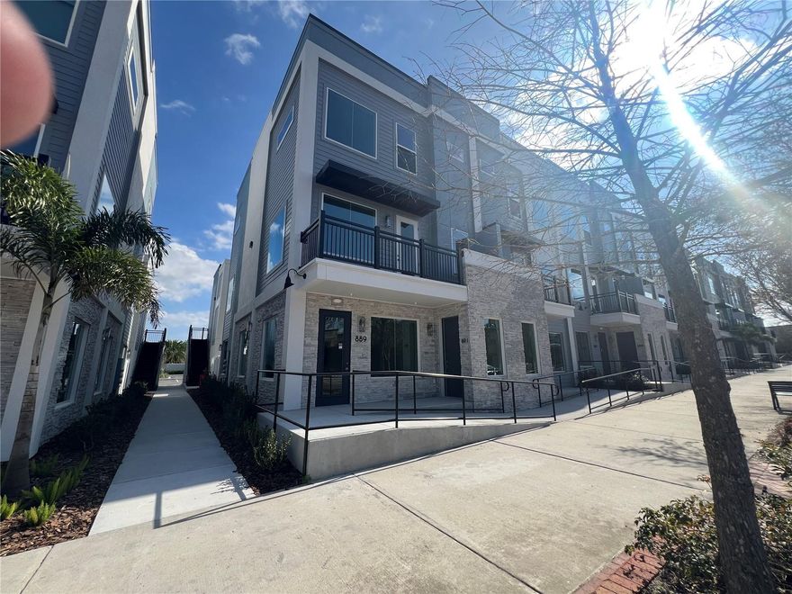 One or more photo(s) has been virtually staged. Nearly New Construction(1 yr) oversized luxury City Place Townhome with many upgrades. This corner unit features just over 2000 heated square feet with all bedrooms on top floor and kitchen/living area on second floor providing panoramic views of Oviedo on the Park. The upgraded kitchen includes quartz countertops, beautiful backsplash, premium Samsung appliances, built-in wine cooler and large pantry space. Expansive kitchen island has space for several counter height stools. Living area has large balcony overlooking the Food Factory, Park and Center Lake so you never have to miss an event whether DJ or live music, World Market, Food Truck Thursdays or Movie in the Park. On the top floor, the primary bedroom features an ensuite bath with the same upgraded finishes as the kitchen. Wake to breathtaking views of Center Lake from the multitude of windows in the primary bedroom. The additional bedrooms are on the opposite side of the top floor with upgraded hall bath to share. All bedrooms & living room feature dedicated high-speed internet hardwiring, also pre-wired secure camera hook up and fire suppression sprinklers in all rooms including garage. All staircases have been upgraded to the Laminate flooring that runs through the living area and all bedrooms. Enjoy the beautiful Florida weather all year in the private rear patio and also from the second level balcony overlooking all of Oviedo on the Park. Rear facing detached garage accommodates oversized vehicles and your electric vehicles with EV charging plug. Conveniently located in Central Oviedo, minutes to UCF, Research Park, A-rated public schools, Oviedo Amphitheater & Cultural Center at Center Lake Park, the Cross Seminole Bike Trail, Shane Kelley Park and Oviedo Mall. Less than 2 tenths of a mile from Ford's Garage, Teriyaki Madness, Maple Street Biscuit Company, Five Guys, Marlow's Tavern, Panera Bread, Starbucks, Chipotle, 407 Cafe, Tabla, Crazy Cork Wine Bar and many more! Don't miss this opportunity to Live, Work and Play in Oviedo's newest community! Also available separately is a detached 1 bedroom apartment over the garage.