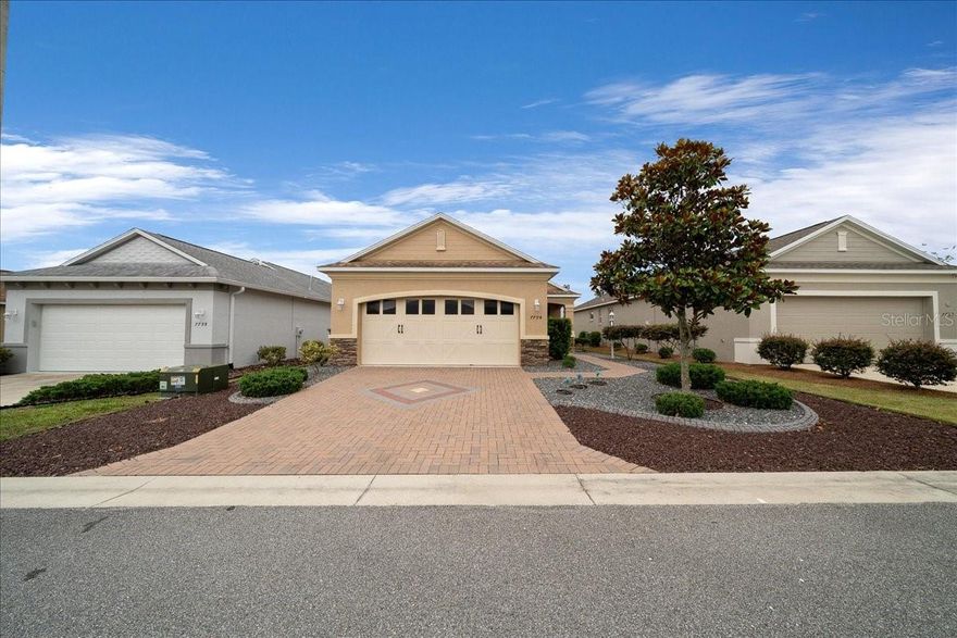 Welcome to effortless Florida living in the highly sought-after Indigo East subdivision of On Top of the World. This beautifully upgraded 3-bedroom, 2-bath home with a 2-car garage delivers the perfect combination of style, comfort, and truly low-maintenance living.
Exceptional curb appeal sets the tone from the moment you arrive, with professionally upgraded landscaping and zero lawn to mow. A custom garage door, personally selected during construction, adds a distinctive finishing touch. Step inside to find elegant porcelain tile flowing throughout the main living areas, with warm carpeting in two of the bedrooms.
At the heart of the home, the spacious kitchen was designed to impress, featuring granite countertops, a chef-style gas stove, an oversized peninsula with breakfast bar seating, abundant cabinetry, and exceptional pantry storage. Large doors and expansive sliding glass doors bathe the home in natural light and open seamlessly to a screened porch, your private retreat for enjoying Florida's beautiful weather year-round.
Thoughtful upgrades continue throughout, including generous closet space, wide entryways for easy accessibility, and quality finishes that truly set this home apart.
Beyond your front door, On Top of the World delivers a resort-style lifestyle with amenities to match including a sparkling community pool, state-of-the-art indoor and outdoor fitness centers and a dedicated dog park. Best of all, this is a golf cart-friendly community, making it easy to cruise to the pool, gym, or neighborhood gatherings without ever getting in your car. Whether you're swimming laps, hitting the gym, or strolling with your four-legged companion, there's something here for every part of your day.
Move in with everything you need, this home can be purchased fully furnished or completely empty, whichever works best for you. Either way, this is the On Top of the World lifestyle at its finest.