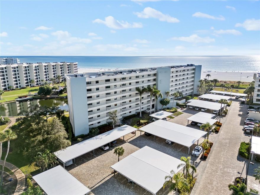 Brilliant views of the sparkling waters of the Gulf of Mexico captivate from this third floor unit in the exquisite Gulf & Bay Club on Siesta Key. Located in the coveted building E with southern exposure, this end unit offers additional windows that allow the warm Florida sunshine to flood your light and bright living space. This unit has been tastefully updated with ample recessed lighting and charming plantation shutters throughout. Create your favorite fare for family and friends in the kitchen with bright white cabinets contrasted by the stunning black granite countertops. Stay organized or work from home in your complete office alcove just off the kitchen. With 1,335 square feet of living space, an open concept from kitchen through to the spacious lanai, providing an additional 136 square feet, offers great space for entertaining, including countertop seating and dining space that comfortably seats 6. The comfort continues to the owner’s suite and guest quarters, both offering nicely appointed baths featuring walk in showers. Situated on 32 acres of perfectly manicured tropical landscaping, the gated and guarded Gulf & Bay Club offers an enviable lifestyle with 800 feet of private beach; three heated swimming pools; two clubhouses; tennis, pickleball, racquetball and basketball courts; walking trails amongst the lush landscape; media and library facilities and much, much more. Conveniences are endless with in unit laundry, a recently renovated covered car port, electric car charging stations, along with an engaging social calendar with organized events, games and cultural outings. Venture away from Siesta Key for a day and explore the spectacular arts and culture of Florida’s vibrant gulf coast communities. The quintessential and elevated island life can be yours at the Gulf & Bay Club on Siesta Key.