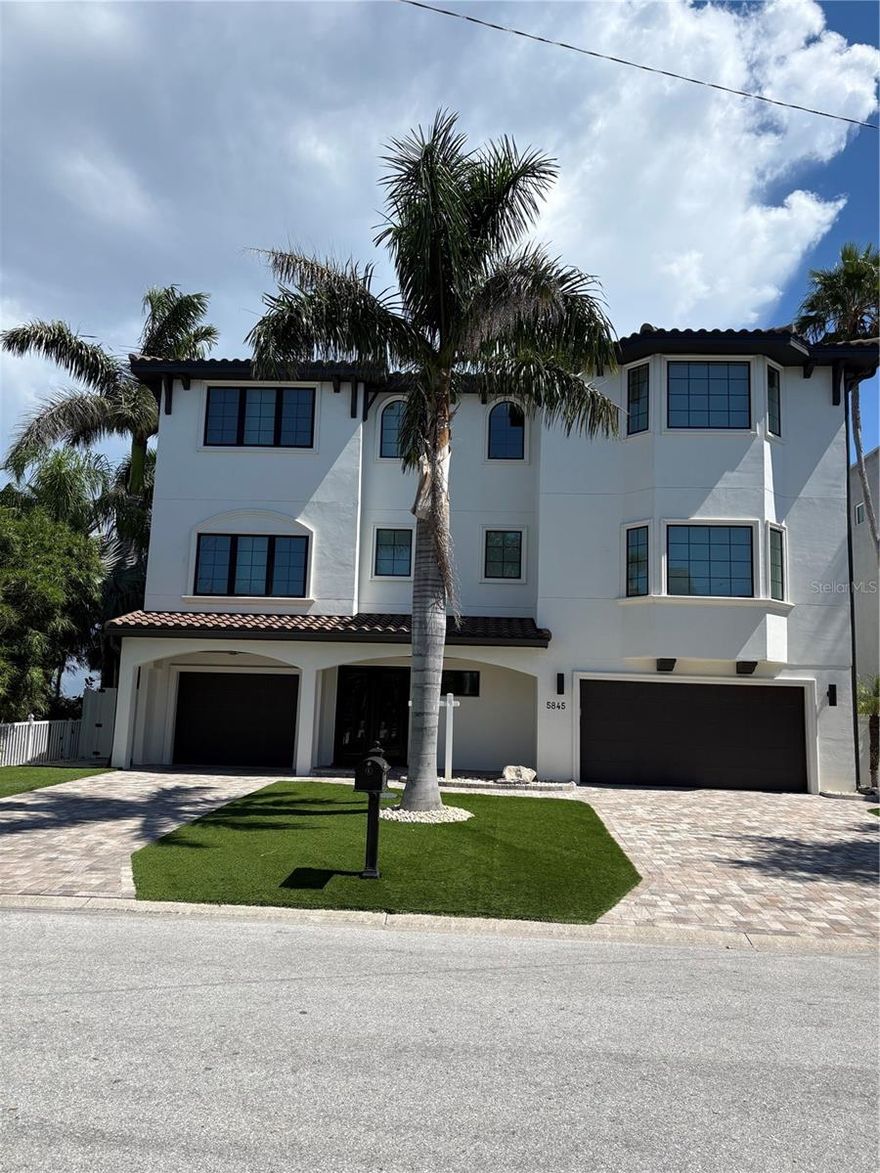 If you are you looking for open water, you've found it on Boca Ciega Bay.  Boasting a 30,000 lb high speed boat lift with composite decking, and a step down for easy boat access.  When you're not out boating, enjoy fishing off your dock as dolphin and manatee swim-by.  Ground level includes heated pool and attached spa and water features.  Enjoy sitting around a large stone-built gas fire-pit, surrounded by artificial turf and mature palm trees. Let's begin on the ground level; this property comes with a brand-new outdoor kitchen, equipped with new ice maker, refrigerator, granite countertops and seating for up to 12.  All cabinets are outdoor rated. There's more; an additional kitchen area with a gas grill-top BBQ.  Sonos speakers carry the music all the way to the dock.  

A 3-car garage and tandem parking for 5 cars or use it as a 3-car garage and an exercise area with air-conditioning, mirrors and TV all included! Plenty of custom built-in storage and workbench for all your chores.

Time to enter through the front door......designer custom steel doors leading to the foyer, additional storage and elevator service. On the 2nd level, the view begins!  There's 4-sliders with two 8' high glass panels on both sides, affording a panoramic open-water view of Boca Ciega Bay!  To the left you will find a custom wall with a 98" electric fireplace coupled with a 98" TV and a Sonos sound system; this great room is outrageous.  In the center of the room, there's ample space for a dining table that seats 8, with a custom contemporary chandelier.  Further to the right, is a large kitchen boasting two 10' islands!






There's a Butler's Pantry and walk-in pantry; perfect for your coffee station.  Now walk out to the 12' x 36' tiled patio with complete outdoor kitchen including refrigerator, sink and BBQ and don't forget the magnificent view!

Stroll back inside and there's a custom-built bar with seating for 12.  Complementing this bar is the 3rd sink, a dishwasher and a combination wine cooler, fridge and freezer.  A full-size TV, Sonos soundbar and rear speakers complete this unique space.  

Also on this floor is a flex room measuring 16' x 16' with a bay window.   This room can be used as a formal dining room or an office.  A half bath is available in the adjoining hall for convenience.  Bedroom #1 is 15' x 16' ensuite with a walk-in closet

Onto the elevator to the 3rd level.  As the door opens you are greeted with a 17' x 22' additional flex room with Sonos TV and Soundbar.  This room has 3 sliders opening to an even grander view of Boca Ciega Bay, with a 12' x 24' tiled patio.  You will also find two additional guest rooms, one of which can be a second Primary Bedroom with an ensuite, 15' x 24', with a grand water view.  The second guest room on this level is 14' x 14'.  Now, enter through double doors to your primary suite, 19' x 27' allowing for second living area with a wet bar, TV with Sonos Soundbar, refrigerator and sink and don't forget the view!  A perfect space for your morning coffee.  Two large walk-in closets, ensuite boasting a large walk-in shower with multiple showerheads.

Experience this exceptional waterfron home with its breathtaking views, elegant finishes, and unparalleled outdoor living spaces! Its a must see home!