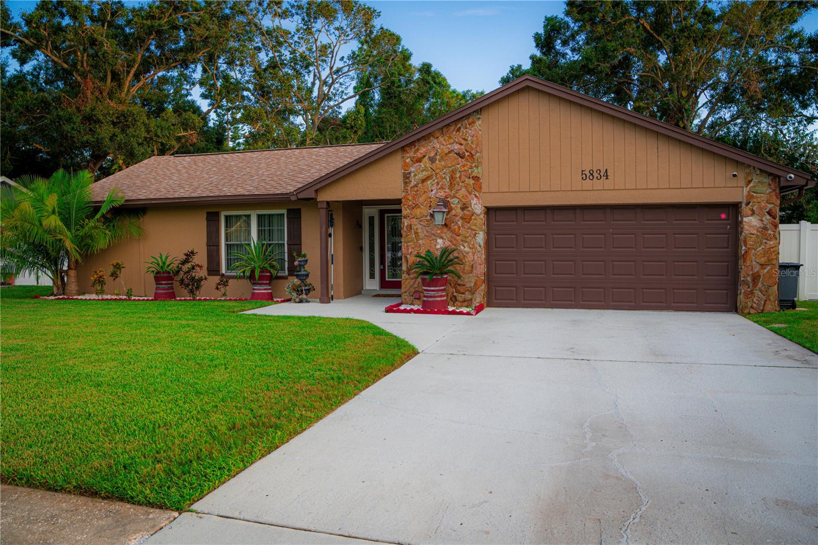 Welcome to your new home and business opportunity in Pinellas Park!
This charming three-bedroom, two-bathroom house offers a unique and highly desirable feature: a fully converted garage operating as a licensed daycare facility with a capacity for 10 infants. This established space, equipped with cribs, play areas, and educational decor, presents an exceptional opportunity for an entrepreneur seeking a home and a ready-to-run business in a thriving community.
The exterior of the home boasts an attractive facade with a well-maintained lawn and mature trees, suggesting a peaceful and inviting atmosphere. The property's design hints at a comfortable and family-friendly environment.
Step inside and discover a spacious and bright living area with elegant flooring and ample natural light. The open-concept kitchen is a highlight, featuring stylish wooden cabinetry, modern stainless steel appliances, and a beautiful tiled backsplash. A convenient breakfast bar with seating offers a casual dining option, perfect for family meals or entertaining. The kitchen flows seamlessly into the living room, creating an ideal space for daily life and gatherings. Beyond the main living areas, the property offers a delightful screened-in patio complete with a relaxing hot tub and comfortable outdoor seating. This private oasis is perfect for unwinding after a long day, enjoying the Florida climate, or entertaining guests. Located in a quiet and friendly neighborhood in Pinellas Park, Florida, this home is conveniently close to schools, parks, and local amenities, making it an ideal choice for families. This property isn't just a house; it's a lifestyle and business package offering comfort, convenience, and entrepreneurial potential.