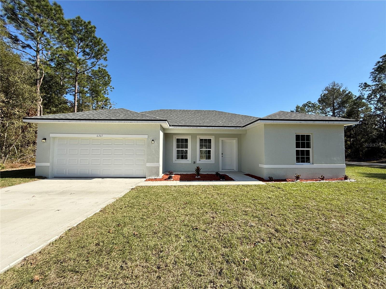 Brand New Home – Ready for Quick Move-In! This modern property is located in a tranquil neighborhood, just 20 minutes from downtown Ocala and 1 hour from downtown Orlando, offering the perfect balance of peaceful living with convenient access to city amenities. Featuring a thoughtfully designed open floor plan, this home includes four spacious bedrooms and two bathrooms, providing ample room for your family’s needs. The kitchen is equipped with sleek, modern cabinetry and top-of-the-line stainless steel appliances, including a stove, refrigerator, garbage disposal, dishwasher, and microwave. Both the kitchen and bathrooms boast beautiful granite countertops, adding an elegant touch to each space. The interior is finished with durable ceramic flooring throughout all rooms and living areas, combining both style and practicality. Additionally, the shower walls are tastefully tiled, enhancing the home's overall aesthetic. This property also offers a premium corner lot, providing extra privacy and space. Don’t miss out on the opportunity to make this brand-new house your home! Schedule your visit today!