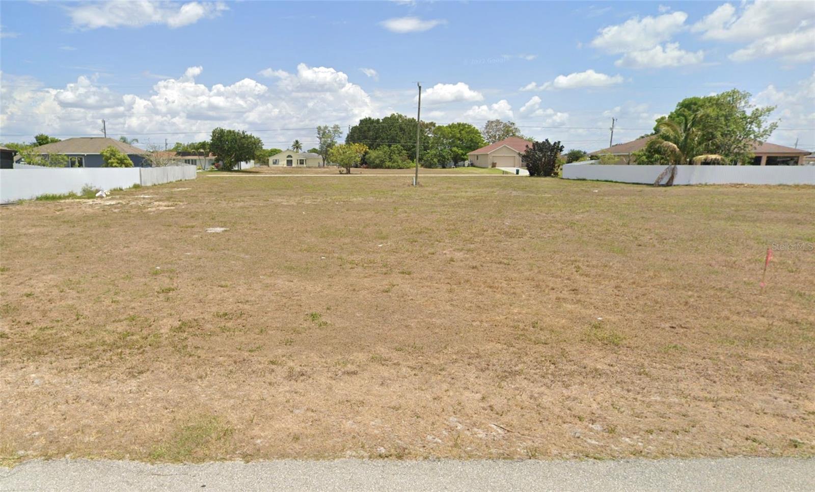 Under contract-accepting backup offers. Nestled in the highly desirable Diplomat neighborhood of Cape Coral, this pristine 10,019sqft vacant lot at 1213 NE 4th Place offers a rare canvas for your dream home. Zoned R1-D and boasting a rectangular 80×125 ft footprint, this parcel delivers plenty of space and flexibility. Located within minutes of Diplomat Elementary, Diplomat Middle, and Mariner High School (GreatSchools scores), this lot is perfect for families seeking both quality and convenience to grocery stores, the carousel boat ramp, restaurants, and stores.
Imagine creating your ideal single-family residence with generous setbacks and space for a pool or extended lanai, and community amenities. With city utilities nearby and a peaceful, established setting, this property presents a fantastic opportunity for builders, investors, or homeowners looking to personalize their coastal oasis.