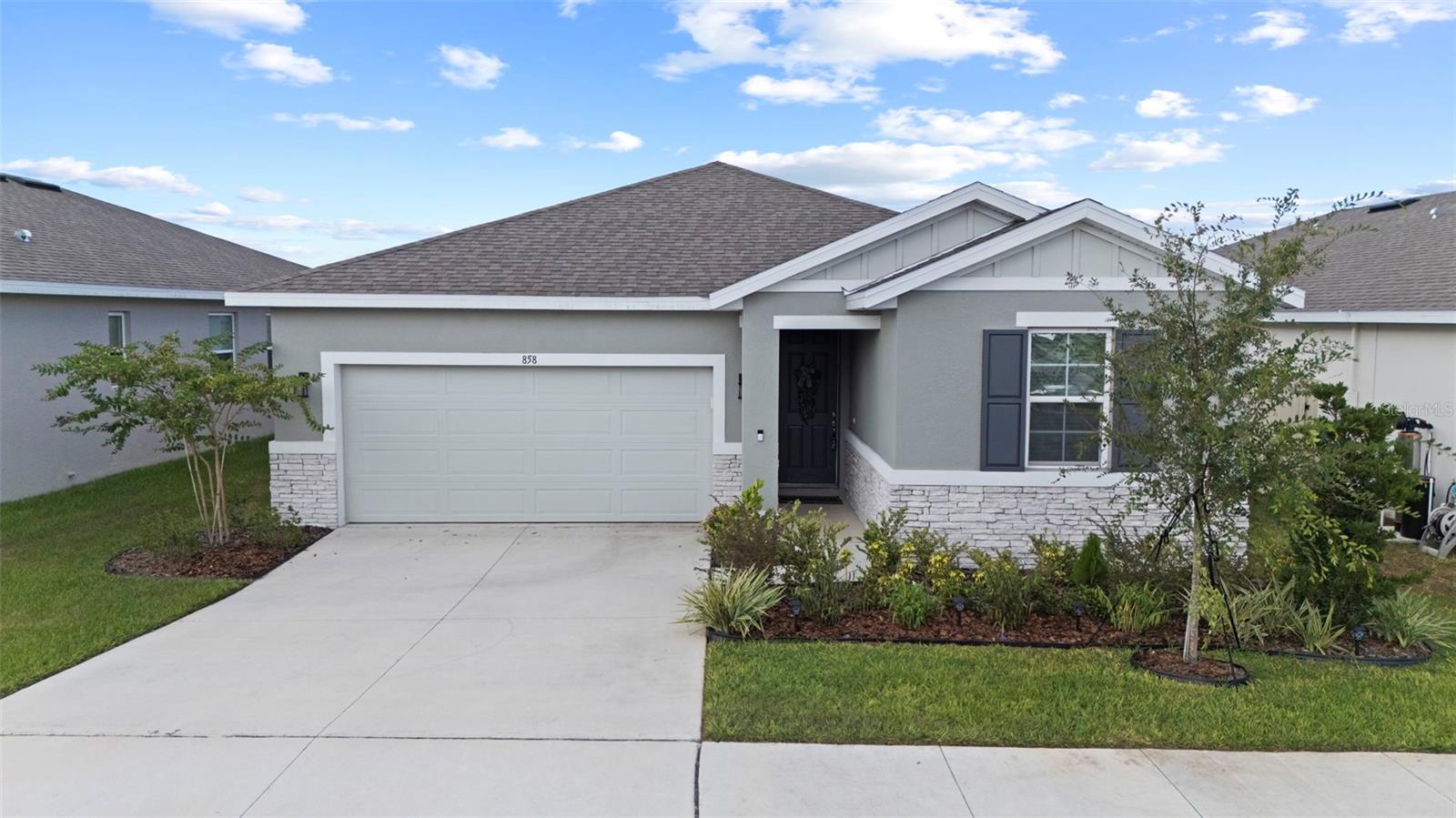 Practically BRAND NEW with Upgrades Galore! Why wait to build when you can move right into this stunning home built in 2024 that’s been thoughtfully upgraded inside and out? From the moment you arrive, the hardi board and brick accented exterior, upgraded landscaping, and fresh mulch set the tone for exceptional curb appeal. Inside, you’ll find a light-filled open layout with wood plank tile flooring throughout the main living areas and LVP in the primary bedroom and bedroom 3 for style and durability. The chef’s kitchen is a true centerpiece, boasting a stylish backsplash, custom lighting, and upgraded fixtures, oversized island and all appliances stay, including washer and dryer! The spacious family room is perfect for entertaining, featuring a mounted TV setup with hidden conduit for wiring for a sleek look, while custom ceiling fans add comfort in every room and even out to the screened lanai. Retreat to the primary suite where the primary walk in shower offers an upgraded handheld shower head and thoughtful finishes. Additional highlights include whole-home blinds, a Ring doorbell, a new vinyl fence, and upgraded exterior details! Practical upgrades like the Generac generator with dedicated outlet, LED can lighting in the garage, and garage door opener bring peace of mind and everyday convenience. Perfectly located, this home offers the best of both worlds! Just about an hour to the thrills of Sebring International Raceway in one direction, and the vibrant city life of Tampa in the other. Whether you’re seeking weekend adventures or quiet evenings at home, this property delivers it all. With modern design, upgraded finishes, and a prime location, this home is move-in ready and just waiting for you! Schedule your personal tour today!