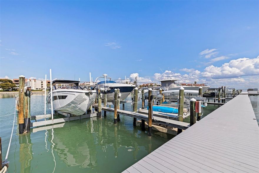 Discover the Waterfront Gem You've Been Dreaming Of! Welcome to a magnificent townhome on the serene island of TIERRA VERDE, Florida, this beautifully designed home has transformed into an unforgettable oasis. Offering 2,128 sq ft of luxurious living space, featuring 3 spacious bedrooms, 3 full baths, a unique 2-car garage, a BOAT SLIP 57 x 21 feet wide and 40,000 lb LIFT, this deepwater slip can accommodate most luxury crafts. Direct access to Tampa Bay and the Gulf of Mexico with no fixed bridges. An extension of this amazing townhome offers a renovated finished air conditioned BONUS ROOM on the ground level with desk space over looking the water, murphy bed and refrigerator. Step inside to find a host of upgrades, including HURRICANE IMPACT WINDOWS AND SLIDERS, plantation shutters, and plush carpeting in the bedrooms. The home boasts a central vacuum system, a cozy fireplace, and a completely remodeled kitchen and living/dining area. The kitchen features exquisite 12x48 Martha's Vineyard Cottage tile, Cambria quartz countertops, and Kitchencraft Aurora European overlay cabinetry with soft-close drawers and doors. Top-of-the-line black stainless KitchenAid appliances with a no-fingerprint finish, including a built-in convection oven and microwave, induction cooktop, counter-depth refrigerator, range hood, and dishwasher, complete this chef's dream. Enjoy breathtaking water views from your living room and master balconies. Direct access to Tampa Bay and the Gulf of Mexico, is a perfect boater's dream! Whether you're cruising to watch the sunset or heading to the nearest key for a day of fishing, the water is your playground. Nestled in the island paradise of Tierra Verde, this waterfront complex offers a community pool and amenities and just steps away from a variety of shops, and marinas(directly across the street). Live life to its fullest as you step outside & take advantage of an island life full of water sports, including boating, kayaking, fishing, & paddle boarding. Delicious restaurants & bars are in close proximity & walkable, which means you're never far from a savory meal or a lively night out. So much more is beyond your oasis, in just minutes, less than 3 miles, you can reach Award Winning Fort De Soto or take a wonderful bike ride right from your front door, experience Historic Pass-a-Grille Beach, Cycling on the Pinellas County Trails, Gulf Beaches, & vibrant Downtown St. Petersburg. When adventure calls further afield, I-275 & Tampa International Airport are convenient and ready to whisk you away to a getaway destination. This exceptional home promises to impress and truly exceeds model home standards. An invitation to an extraordinary way of life and the story of your island adventure begins here on Tierra Verde! *Furniture Negotiable*