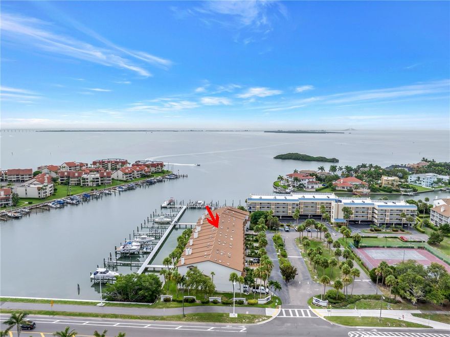 Discover the WATERFRONT Gem You've Been Dreaming Of! Welcome to a magnificent townhome on the serene island of TIERRA VERDE, Florida, this beautifully designed home has transformed into an unforgettable oasis. Offering 2,128 sq ft of luxurious living space, featuring 3 spacious bedrooms, 3 full baths, a unique 2-car garage, a BOAT SLIP 57 x 21 feet wide and 40,000 lb LIFT, this deepwater slip can accommodate most luxury crafts. Direct access to Tampa Bay and the Gulf of Mexico with no fixed bridges. An extension of this amazing townhome offers a renovated finished air conditioned BONUS ROOM on the ground level with desk space over looking the water, murphy bed and refrigerator. Step inside to find a host of upgrades, including HURRICANE IMPACT WINDOWS AND SLIDERS, plantation shutters, and plush carpeting in the bedrooms. The home boasts a central vacuum system, a cozy fireplace, and a completely remodeled kitchen and living/dining area. The kitchen features exquisite 12x48 Martha's Vineyard Cottage tile, Cambria quartz countertops, and Kitchencraft Aurora European overlay cabinetry with soft-close drawers and doors. Top-of-the-line black stainless KitchenAid appliances with a no-fingerprint finish, including a built-in convection oven and microwave, induction cooktop, counter-depth refrigerator, range hood, and dishwasher, complete this chef's dream. Enjoy breathtaking water views from your living room and master balconies. Direct access to Tampa Bay and the Gulf of Mexico, is a perfect boater's dream! Whether you're cruising to watch the sunset or heading to the nearest key for a day of fishing, the water is your playground. Nestled in the island paradise of Tierra Verde, this waterfront complex offers a community pool and amenities and just steps away from a variety of shops, and marinas(directly across the street). Live life to its fullest as you step outside & take advantage of an island life full of water sports, including boating, kayaking, fishing, & paddle boarding. Delicious restaurants & bars are in close proximity & walkable, which means you're never far from a savory meal or a lively night out. So much more is beyond your oasis, in just minutes, less than 3 miles, you can reach Award Winning Fort De Soto or take a wonderful bike ride right from your front door, experience Historic Pass-a-Grille Beach, Cycling on the Pinellas County Trails, Gulf Beaches, & vibrant Downtown St. Petersburg. When adventure calls further afield, I-275 & Tampa International Airport are convenient and ready to whisk you away to a getaway destination. This exceptional home promises to impress and truly exceeds model home standards. An invitation to an extraordinary way of life and the story of your island adventure begins here on Tierra Verde! *Furniture Negotiable*