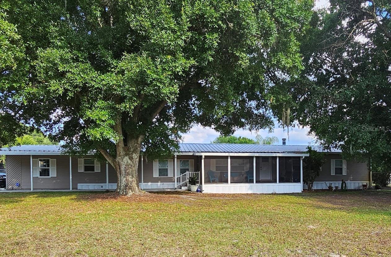 Don't let this one get by you! Beautifully maintained manufactured home that's in move-in condition. This is a large home with many living spaces inside & out. Large 1-acre corner lot with lots of shade. Out buildings that anyone will love to have. No HOA. 12x50x14' tall RV carport w/ 50amp electric service & septic hook-up. Detached garage 30x50 that's insulated w/ a/c, office and a car lift too. Numerous additional garages, sheds and carports. Neighborhood boat ramp & park to Lake Grassey. Back yard is 5' chain link fenced. Located 3/4-mile south of SR 540. 1-block off of Spirit Lake Road. Winter Haven. Nice well kept area.