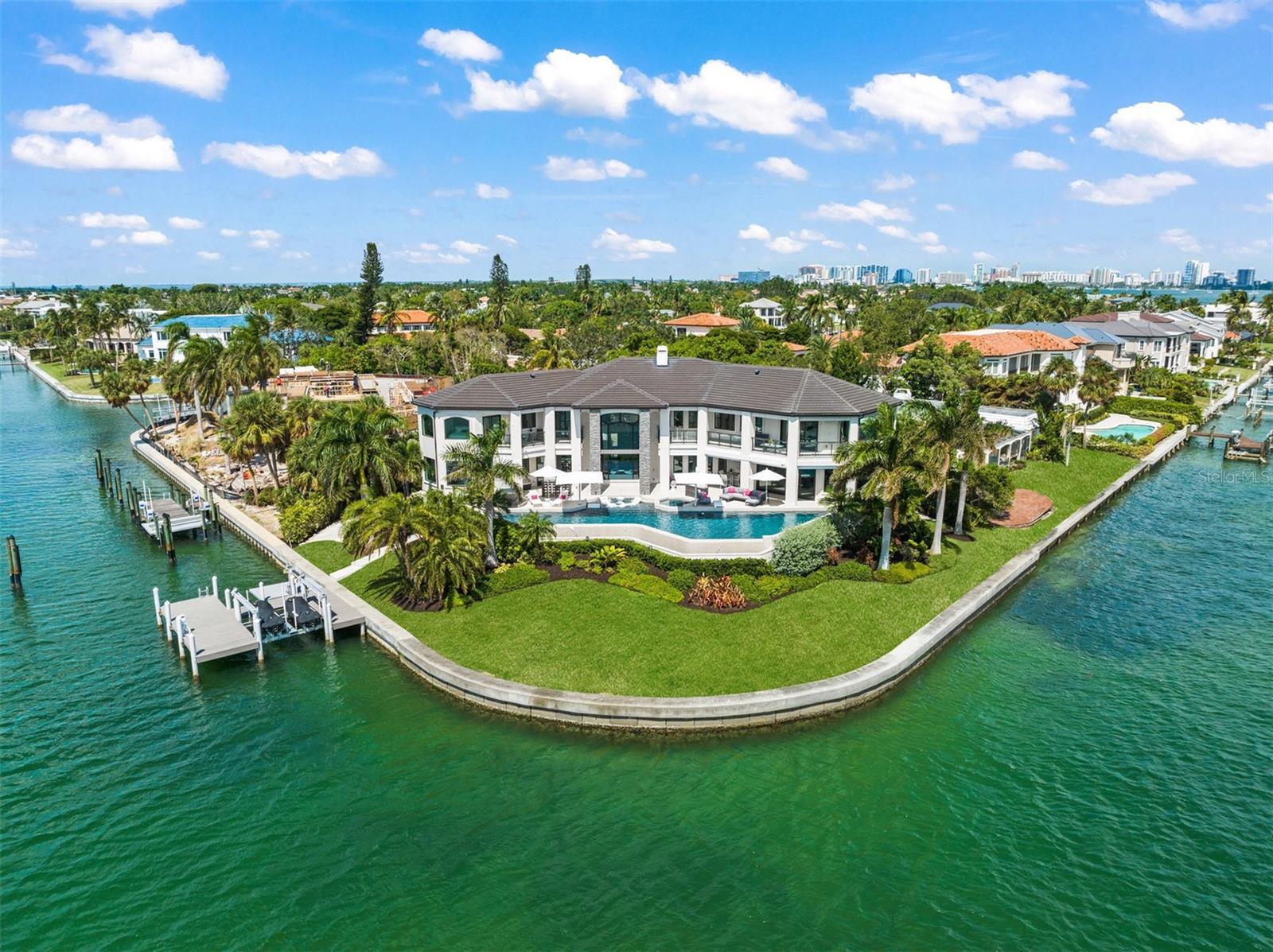 Discover an unparalleled waterfront oasis nestled on the southern tip of desirable Bird Key. Sarasota is consistently recognized as one of the best places to live and retire in the U.S. This remarkable estate, just minutes from St Armands, downtown cultural venues, fine dining and pristine beaches, offers the pinnacle of luxury living.
This residence boasts the absolute best location and views in all of Sarasota, with uninterrupted 270 degree panorama of Big Pass and its beautiful sandy beaches. Arguably the finest lot in all of Sarasota. Only the finest materials and appliances were used to construct this beautiful masterpiece. With 238 feet of seawall, this property can graciously accommodate your yacht. Wake up to mesmerizing sunrises from the primary bedroom and enjoy cocktails on the lanai as the sun sets in the horizon. Privacy is paramount with a thoughtful designed lot layout that creates the sensation of your own private island.
The 75 foot PebbleTec infinity edge lap pool and hot tub beckon for relaxation, while Italian porcelain tile flows seamlessly from the main floor to the outdoor entertaining areas. Boating and water sports enthusiasts will revel in the convenience of the sports dock, capable of accommodating an additional boat lift, and easy access to the Gulf for exceptional fishing and boating. Meticulously renovated from the studs up over the past four years, it boasts new hurricane-rated windows, roof, electrical wiring, plumbing, HVAC, level 5 finishing, floors, cabinetry, doors, floor plan, Polyaspartic garage floors and more!
With six en suite bedrooms, a pool bath and a powder room, as well as a flex room perfect for an office, workout room or art studio, this residence is designed for both comfort and functionality. This remarkable home also features a spacious 3,100 square foot non- conforming lower-level space.
The professionally designed contemporary interior by Apex-Studio Santa Maria perfectly complements the open layout, creating an ideal space for the best entertaining and daily living.
Indulge in the epitome of luxury and waterfront living in this Sarasota masterpiece.
Your dream home awaits!