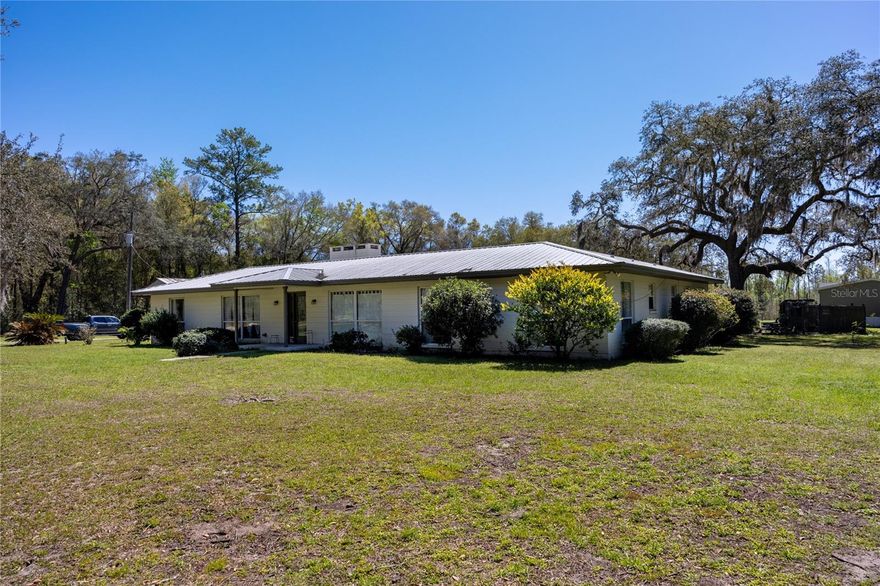 One or more photo(s) has been virtually staged. Over 10 Acres! Multi-family compound. One house is a 4 bedroom and 2- bathroom, The manufactured home is a three bedroom and two bathrooms. Additionally, there is she-shed. Country living in your own compound. This property offers two residences, making it ideal for multi-generational living. This is a retreat and a homestead to grow with loved ones. The main house is block with a spacious interior and an oversized living room. Granite counters in the kitchen with modern cabinets and self-closing drawers. Plenty of room outside for a firepit and a pole barn to house all of your outdoor toys. The second house is a 2021 manufactured home with textured walls in the main living area and plenty of space. The lush woods are great for hunting or exploring nature's beauty. The "she-shed" is an added treat. Electric charging station outside as well. Make this your home. One or more rooms are virtually stagged.