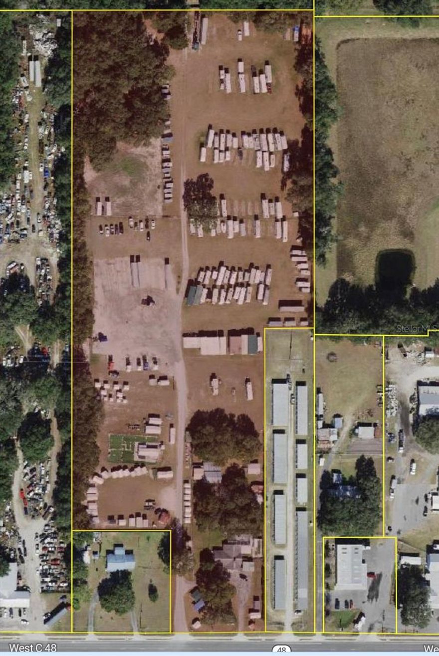 Rare 12.5 acre, commercially zoned property with high visibility, and high traffic potential.  Located less than one mile from I-75, and major retailers,   Walmart, Starbucks, restaurants, and fast food. The Heavy Commercial (CH) zoning offers flexible use options. Utilities available on-site. Flat land, ideal for development.

12.5-acre commercial property with 200 ft of frontage. Currently used for outdoor storage and a shed business. Includes a pole barn/workshop, sheds, and carports. The front residential house is converted to office space. Future Land Use of Commercial with a 0.5 Floor Area Ratio, and Heavy Commercial (CH) zoning which allows many possible use for developers. You will not find another property for sale of this size zoned commercial in this area.