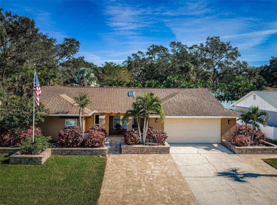 STUNNING and impeccably maintained! This residence has undergone a MAXIMUM level of UPGRADES, showcasing a captivating 3-bedroom plus Office, 2-bathroom with an EXPANSIVE (14x28) IN-GROUND POOL – a true sanctuary. Just over 2 miles to HONEYMOON ISLAND and DOWNTOWN PALM HARBOR. The property has MATURE landscaping and a PAVER driveway, creating an inviting entrance.

Step inside to experience the elegance of VAULTED Ceilings, RICH flooring, and thick baseboards. The quality upgrades continue with a ROOF replacement in 2014, a TRANE HVAC system installed in 2015, and a CENTRAL VAC SYSTEM. The showstopper is the SALT WATER POOL, boasting an impressive 8.5ft depth and a deep blue PEBBLE Tech finish – a true marvel.

The interior is equally impressive, featuring a GORGEOUS, UPDATED kitchen with SOLID SURFACE COUNTERTOPS, STAINLESS Appliances, and SOFT CLOSE doors/drawers. The Master Bath remodel includes a DOUBLE VANITY, TUB, and a WALK-IN SHOWER. Every closet is equipped with BUILT-IN CLOSET SYSTEMS.

This home effortlessly caters to both indoor and outdoor living, making it perfect for entertaining. Picture yourself in an atmosphere of SERENITY, enhanced by impeccable CURB APPEAL, a PROPANE Fire Pit, LUSH MATURE LANDSCAPING, and your own TROPICAL OASIS! The property comes complete with Cabana/patio furniture, Ring Doorbell, Utility Refrig, Storage Shed, and a Pool Storage box. Pride of ownership is evident throughout.