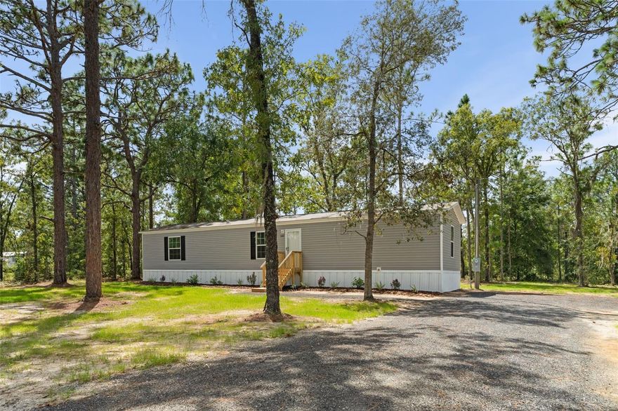 Brand new 3BD/2BA Champion Prime manufactured home on .92 acres in Bronson, FL! This move-in ready home offers 1,001 sq. ft. of living space, designed for efficiency, durability, and comfort. Built to Wind Zone II standards and Energy Star certified, it includes a brand-new well and septic system, fresh millings driveway, and professional landscaping for curb appeal. The open-concept layout connects the kitchen, dining, and living areas seamlessly, while the kitchen is equipped with Whirlpool appliances including a range/hood, refrigerator, and dishwasher. Additional features include an energy-efficient Rheem hot water heater, spacious functional design, and a one-year home warranty for peace of mind. Enjoy the tranquility of rural living while being just minutes to Gainesville’s shopping, dining, healthcare, and entertainment. Bronson also offers nearby attractions including Devil’s Den Spring, Black Prong Resort, and the Goethe State Forest, making this a great location for outdoor recreation and relaxation. Schedule your private showing today and experience the perfect blend of modern amenities and country charm at 5350 NE 108th Ter, Bronson, FL 32621!